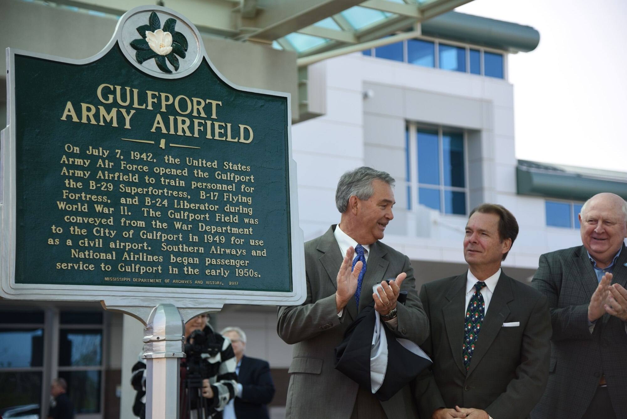 Local dignitaries unveil a historical marker at the entrance of the airport during the Gulfport-Biloxi International Airport 75 Year Commemoration Dec. 13, in Gulfport, Mississippi. The marker was emplaced to honor the airport’s ties to the military dating back to 1942. The U.S. Air Force Band of the West, Nightwatch, also performed during the event. (U.S. Air Force photo by Kemberly Groue)