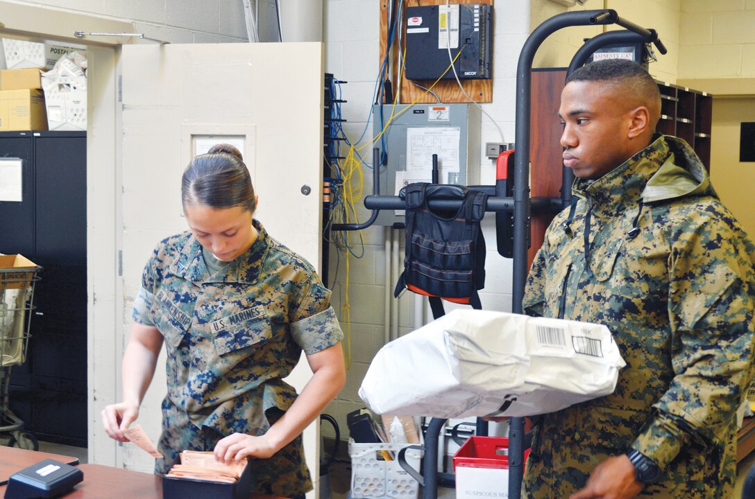 Cpl. Breanna Blankenship works with fellow Marine in filing and directing mail within the post office aboard Marine Corps Base Quantico.