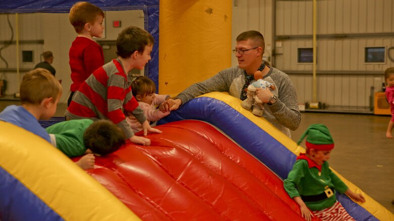 Children play in a bounce house at the Headquarters and Headquarters Squadron Christmas party aboard Marine Corps Recruit Depot Parris Island, Dec. 9. The party was held to foster unit cohesion and celebrate the upcoming holiday season.