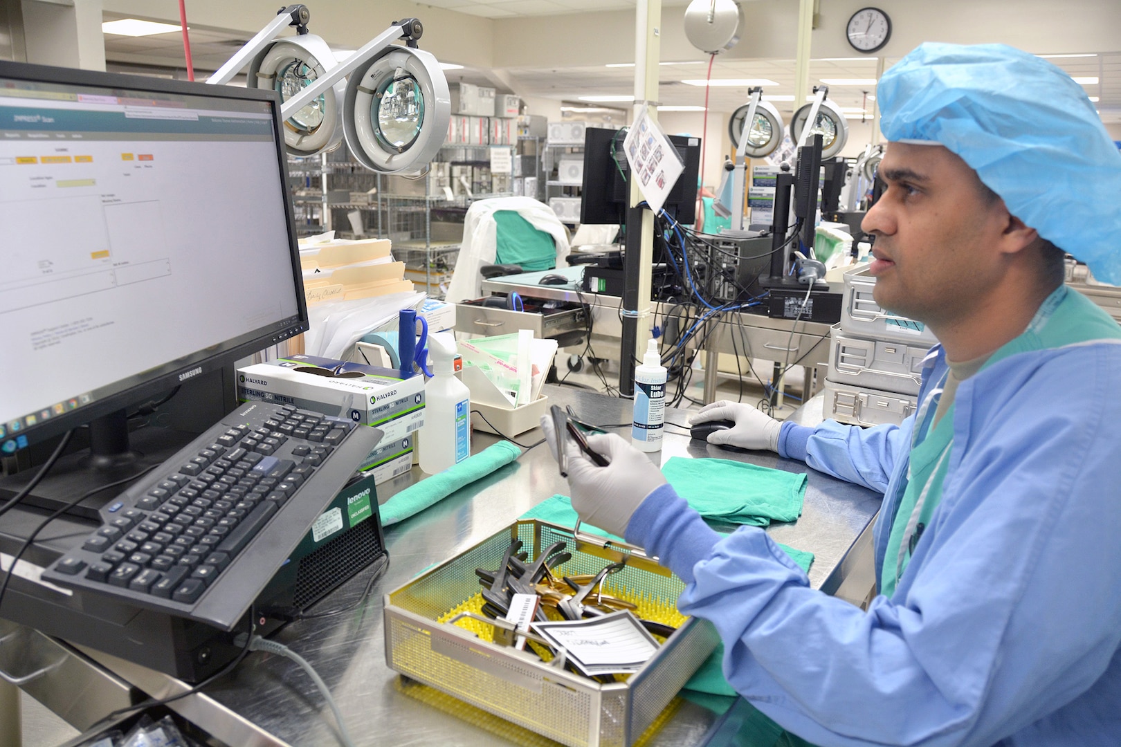 Spc. Thomas Kaithamattam, BAMC’s Sterile Processing and Distribution division technician, inspects surgical instruments as part of the sterilization process.