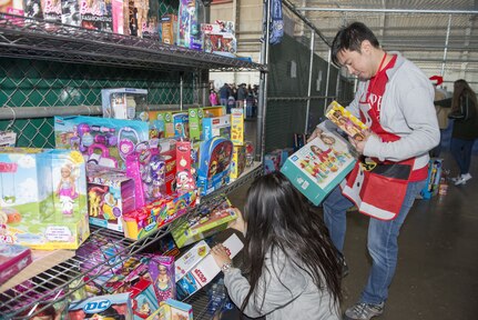 Santa’s helpers sort toys during the 10th Annual San Antonio Military Children’s Holiday Party at Joint Base San Antonio-Lackland Kelly Field Annex, Texas, Dec. 9, 2017.