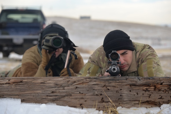 Airman 1st Class Keanu Valle, 341st Security Support Squadron tactical response force nuclear advanced designated marksman, left, and Senior Airman Richard Corpus-Munoz, 341st SSPTS TRF NADM flight trainer, pose for a photo Dec. 12, 2017, at Fort Harrison, Mont.