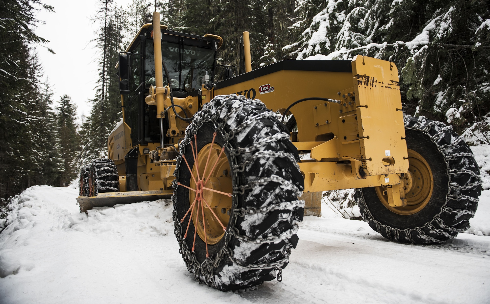 Tech. Sgt. Kyle Hiener, 336th Training Support Squadron field’s operations NCO in-charge, operates a motor-grader to remove snow from roads in the Air Force Survival School Training Area in Cusick, Washington, Dec. 7, 2017. These Airmen are known throughout the Air Force as Civil Engineer “Dirt Boys,” but when they’re a part of the 336th Training Support Squadron, they’re called “Road Runners.” The Road Runners operate various vehicles to clear back roads in the National Forest, to include: motor graders, loaders, bulldozers and dump trucks. (U.S. Air Force photo/Senior Airman Sean Campbell)