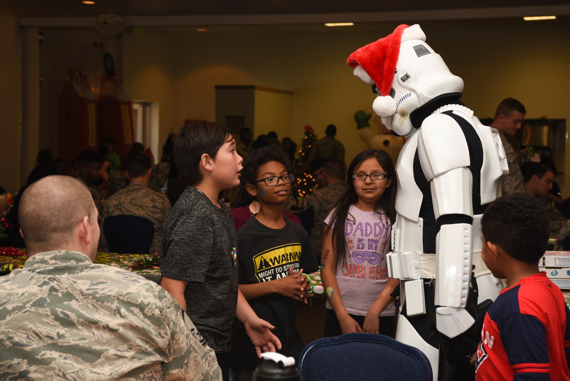 Children talk to a Stormtrooper during Operation Provide Joy at F.E. Warren Air Force Base, on Dec. 9, 2017. This year approximately 45 children attended the event. The event was established to booster community partnership and help local families in need get their children into the holiday spirit. (U.S. Air Force photo by Airman 1st Class Abbigayle Wagner)