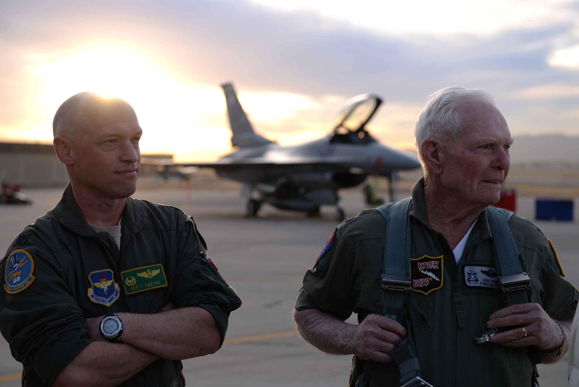 Lt. Col. Matthew Gaetke, 310th Fighter Squadron commander, and retired Air Force pilot Lt. Col. Bob Pardo, watch as an F-16 Fighting Falcons take off at Luke Air Force Base, Ariz., Dec. 12, 2017. Pardo visited Luke to speak at the graduation of the latest 310th FS F-16 Basic Course class. (U.S. Air Force photo/Senior Airman Ridge Shan)