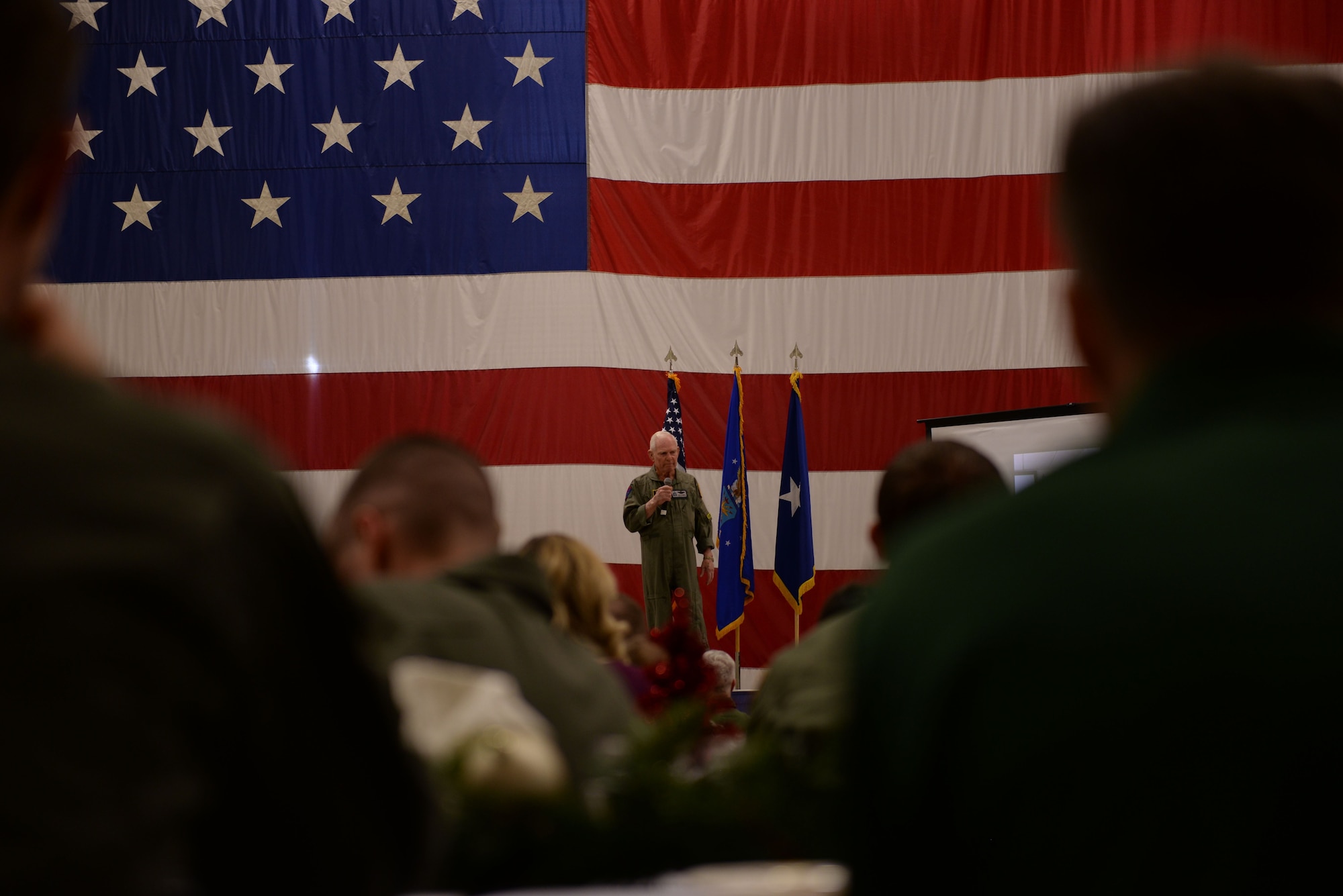 Retired Air Force pilot Lt. Col. Bob Pardo speaks to a group of graduating 310th Fighter Squadron F-16 Basic Course pilots and their friends and families at Luke Air Force Base, Ariz., Dec. 13, 2017. Pardo famously prevented the capture of another aircrew by using his aircraft to push their damaged jet into friendly airspace during the Vietnam War in what came to be known as “Pardo's Push.” (U.S. Air Force photo/Senior Airman Ridge Shan)