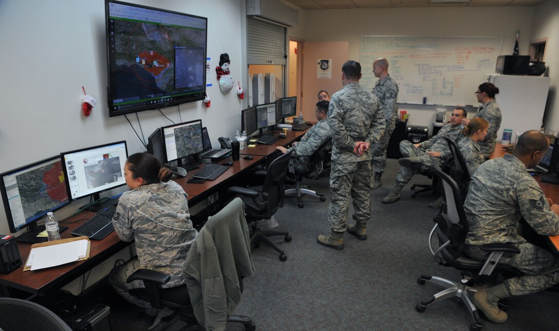 Air National Guard members from the 195th Intelligence, Surveillance, and Reconnaissance Group analyze full-motion video of the Thomas Fire and relay their findings to fire crews on the ground