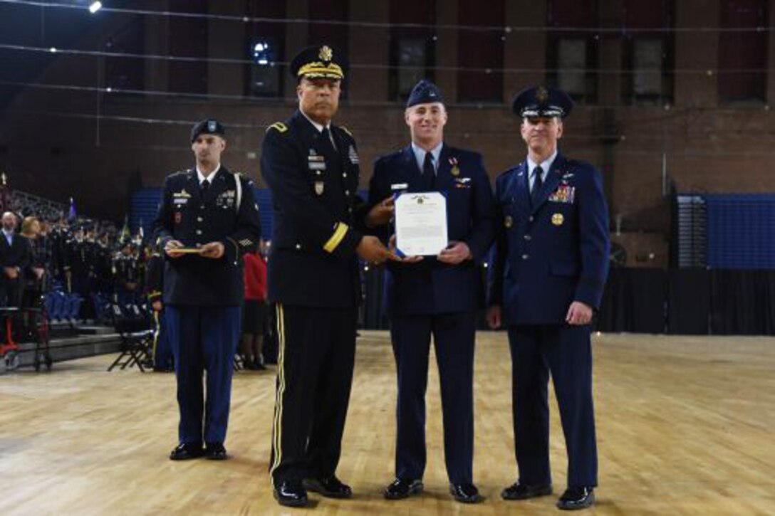 A pilot gets an award during a ceremony.