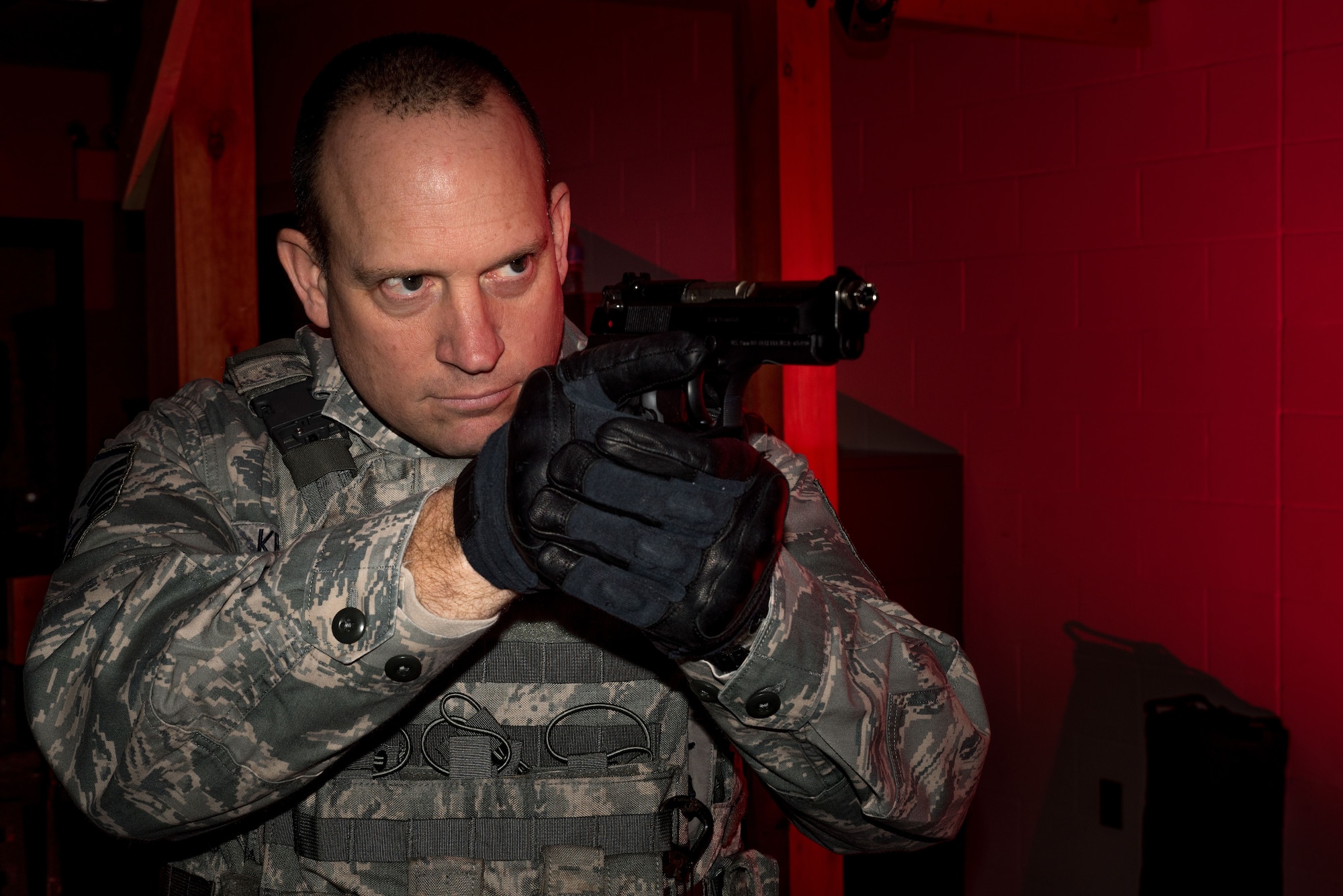 Master Sgt. Glen Kramlinger, Standarization and Evaluations non-commissioned officer in charge for the 934th Security Forces Squadron, takes aim on the Multiple Interactive Learning Objectives simulator at the Minneapolis-St. Paul Air Reserve Station, Minn. on Dec. 14, 2017. The MILO system is an interactive Use-of-Force and tactical judgment training program used to simulate realistic law-enforcement and perimeter security scenarios. (U.S. Air Force photo by Master Sgt. Eric Amidon)