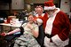 Multiple 932nd Airlift Wing military Airmen and base civilians made a difference by donating their blood inside the 932nd AW headquarters on Dec. 14, 2017, at Scott Air Force Base, Ill.  Hanging out and donating life-saving blood with Santa and Mrs. Claus is Staff Sgt. Kaitlyn Kennedy, 932nd Development and Training Flight Coordinator.  She said, "I'm following in my grandma's example.  She used to donate blood before she passed away, with more than 26 gallons over her lifetime, and I'm carrying on that legacy."  Kennedy has donated over a gallon of blood in less than two years, and with each donation, she knows three lives are saved through the American Red Cross processes.  Every two seconds someone in the United States needs blood due to accidents, transfusions, and cancer treatments.  Approximately 36,000 units of red blood cells are needed every day in America.  (U.S. Air Force photo by Lt. Col. Stan Paregien)