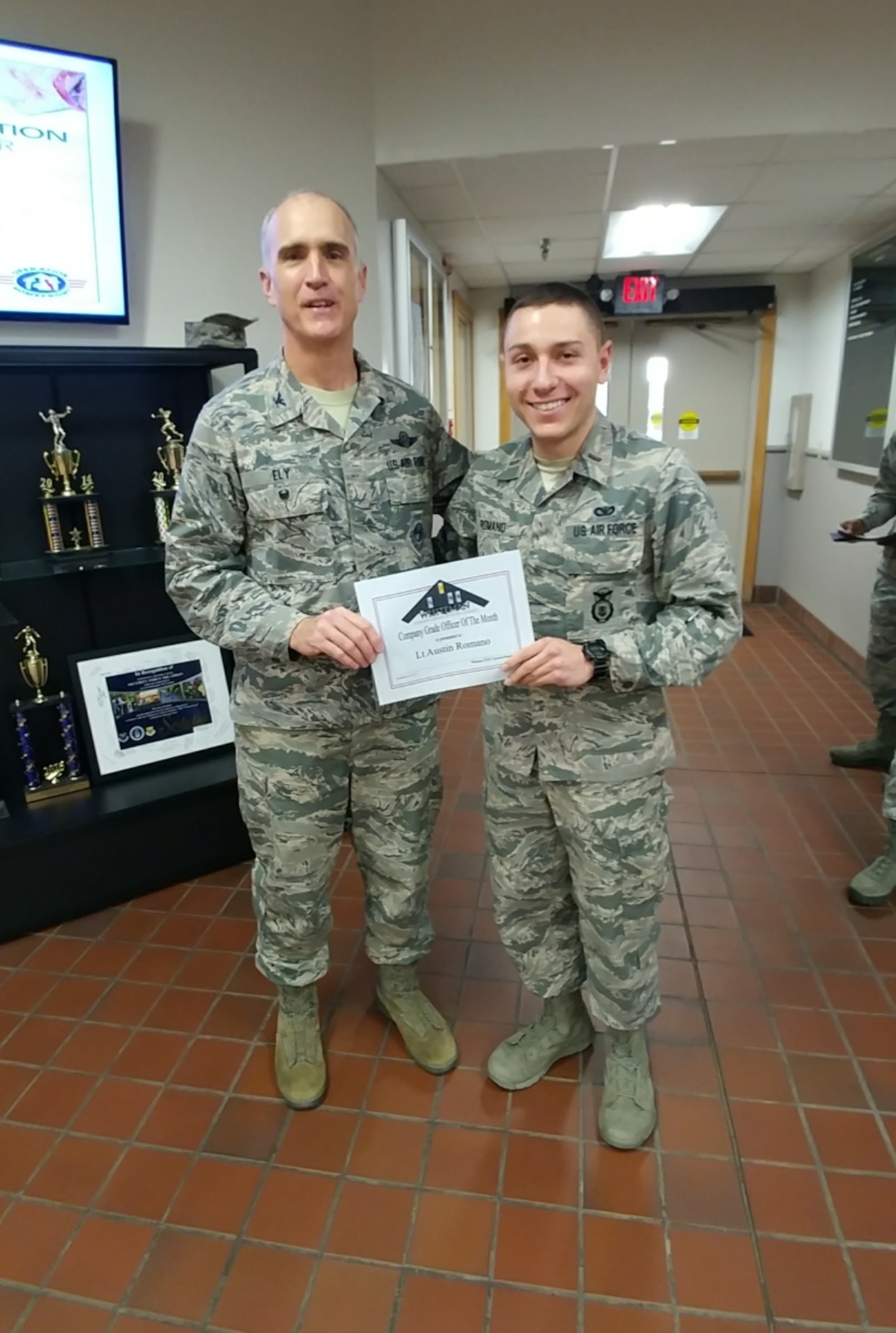 U.S. Air Force 2nd Lt. Austin Romano, the 509th Security Forces Sqaudron commander's support staff section officer in charge, right, receives a Whiteman Company Grade Officer Council (CGOC) Bars and Stars award for the month of September from Col. Mark Ely, the 509th Bomb Wing vice commander, at Whiteman Air Force Base, Mo., Dec. 13, 2017.