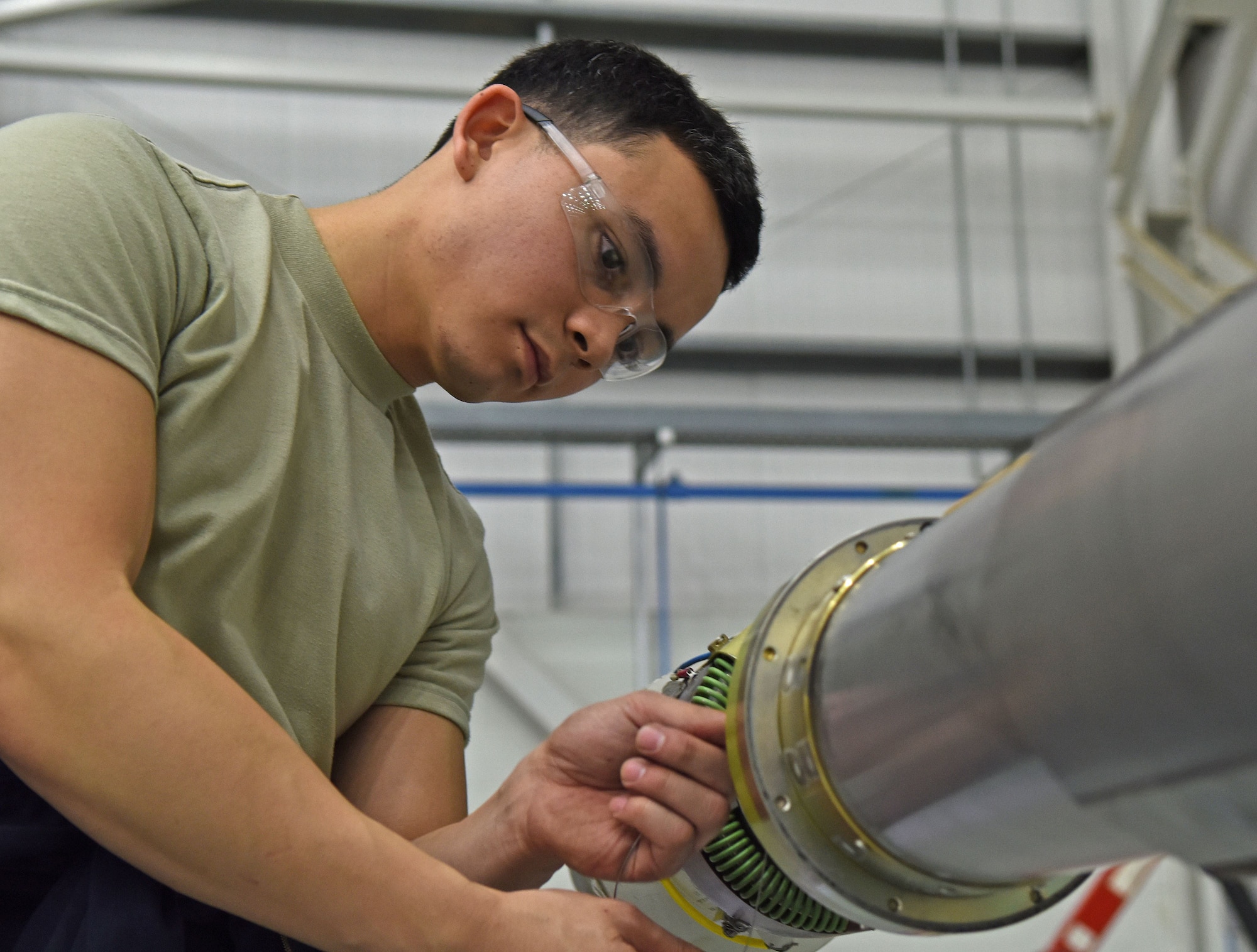 U.S. Air Force Senior Airman Dakota David, 100th Maintenance Squadron hydraulic systems journeyman, works on the boom of a KC-135 Stratotanker during an isochronal inspection on RAF Mildenhall, England, Dec. 13, 2017. During an isochronal inspection of a KC-135, the boom is removed from the aircraft for a more thorough inspection. (U.S. Air Force photo by Airman 1st Class Luke Milano)