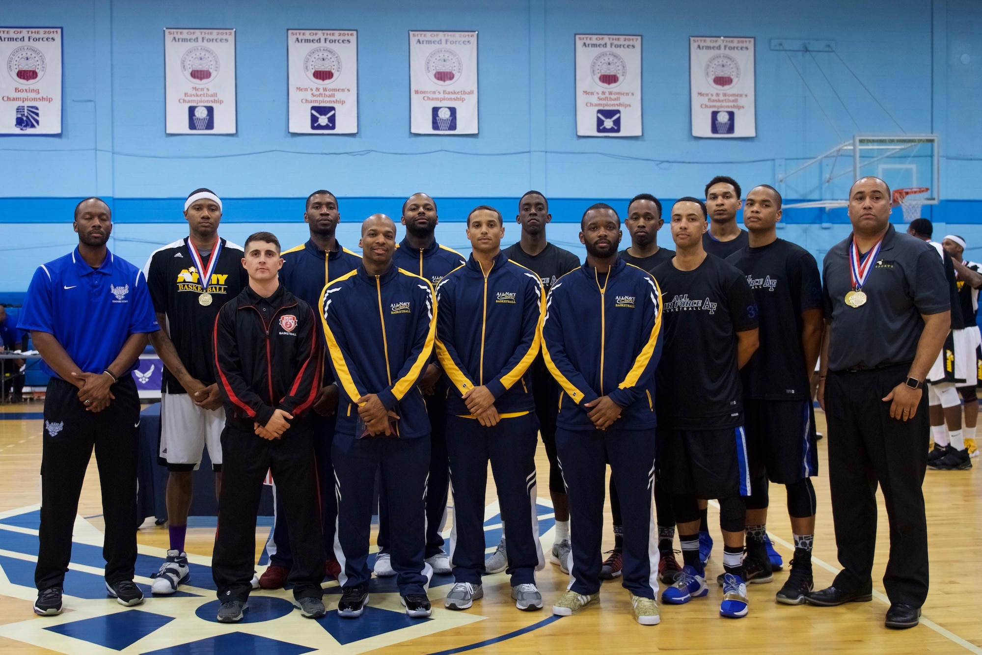 Tech. Sgt. Corey Rucker poses with fellow members of the U.S. Armed Forces Men's Basketball Team at Lackland Air Force Base, Texas, Nov. 7, 2107. The team won gold at the SHAPE International Basketball Tournament in Europe.