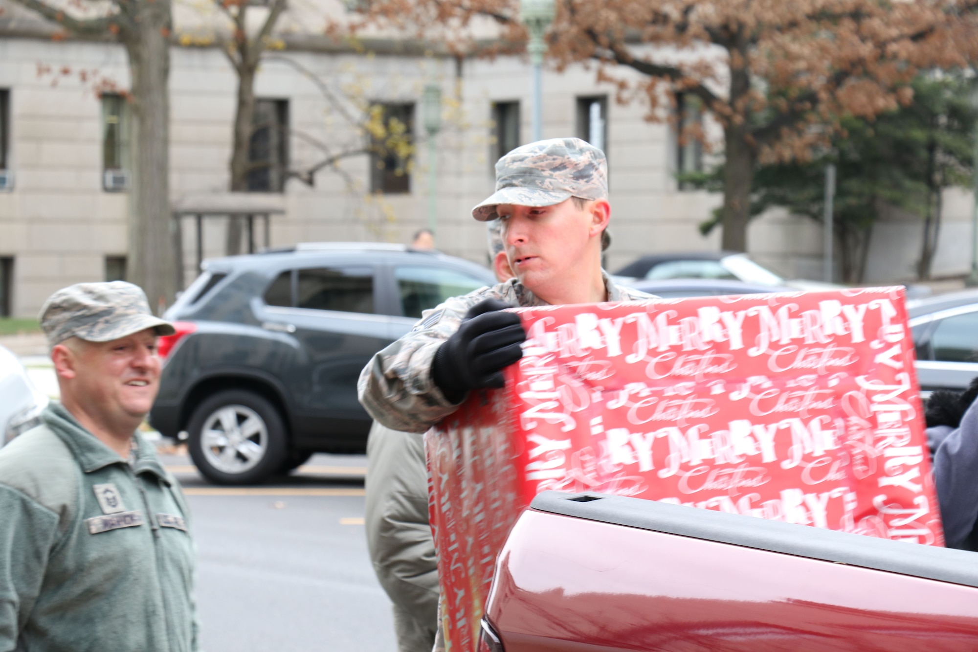During the 2017 Holiday Wish Program, 193rd Regional Support Group Airmen and Pennsylvania Army Guardsmen carry in donated gifts into the Keystone Building, Harrisburg, Pennsylvania, Dec. 6, 2017. After a ceremony, with the help of volunteer state employees, they loaded the gifts into military vehicles and delivered them to participating county assistance offices for distribution to families and individuals.  (U.S. Air National Guard photo by Master Sgt. Culeen Shaffer/Released)