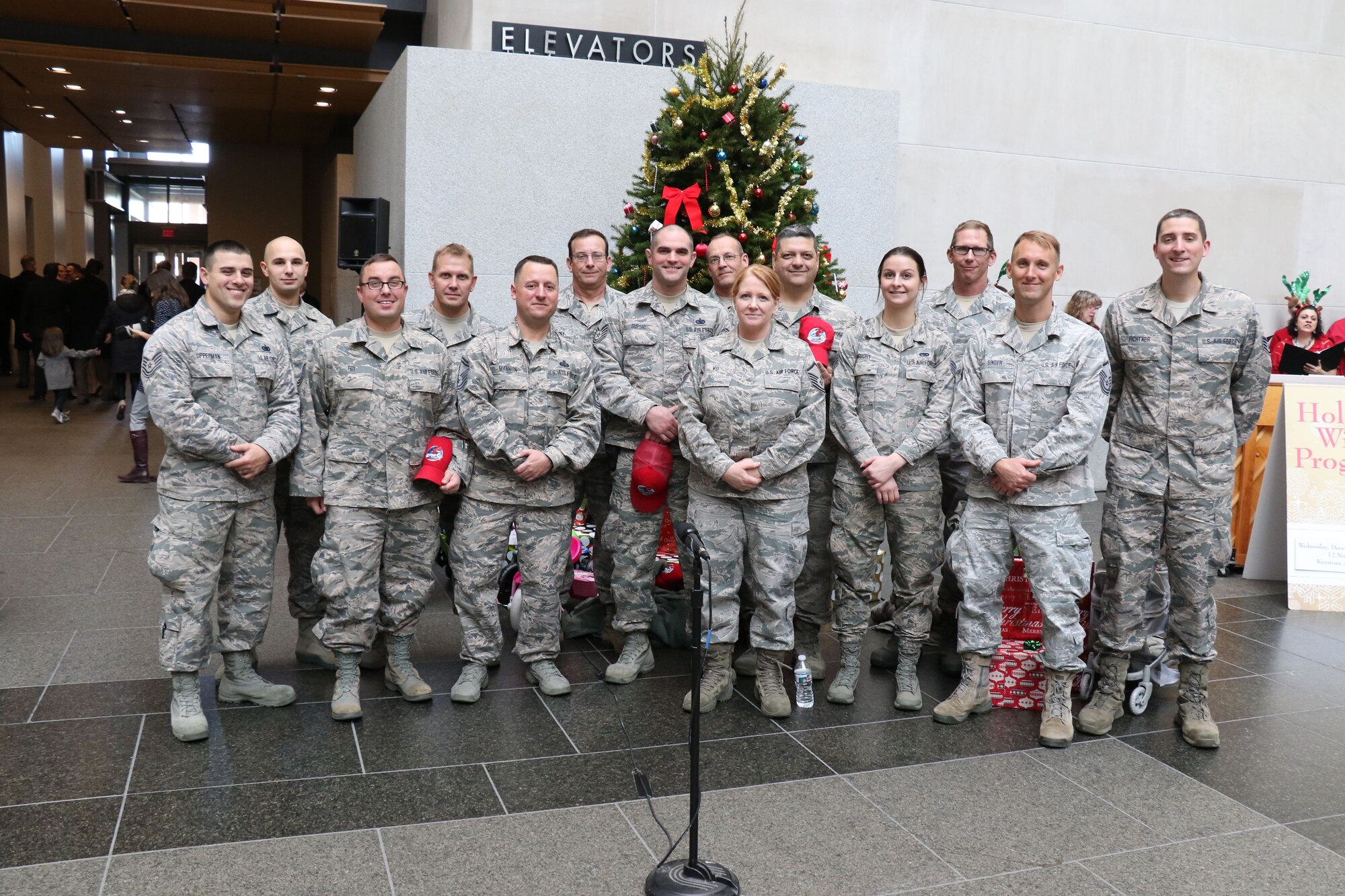 Before loading donated gifts into military vehicles, 193rd Regional Support Group Airmen, pose for a group photo during the 28th annual Holiday Wish Program held at the Keystone Building, Harrisburg, Pennsylvania, Dec. 6, 2017. The Airmen along with Pennsylvania Army Guardsmen delivered the gifts to participating county assistance offices for distribution to families and individuals.  (U.S. Air National Guard photo by Master Sgt. Culeen Shaffer/Released)