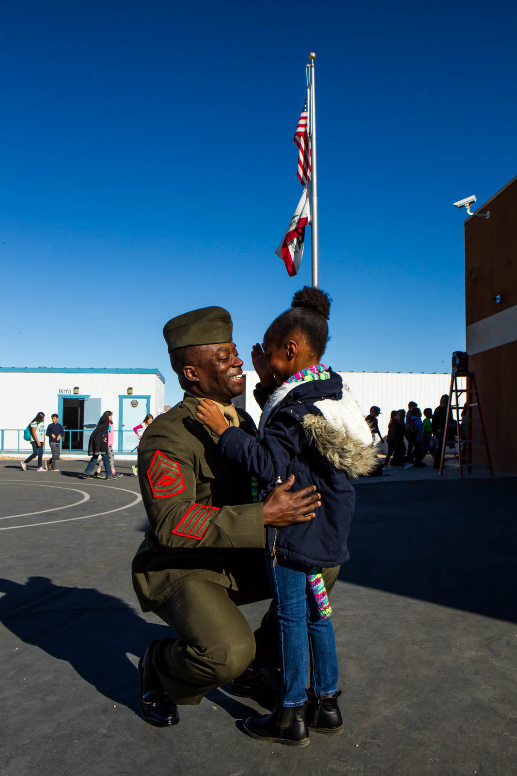 Gunnery Sgt. Jaren Wright, Staff Non-Commissioned Officer in Charge, Marksmanship Training Unit, surprised his daughter during a question-and-answer event at Friendly Hills Elementary School in Joshua Tree, Calif, Dec. 7, 2017. This is the first year the event took place at Friendly Hills. (U.S. Marine Corps photo by Pfc. Rachel K. Porter)