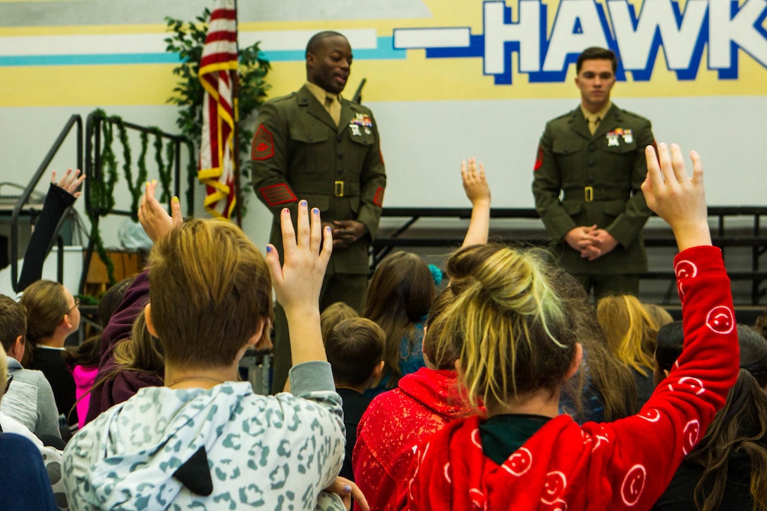 Students raise their hands to ask Marines questions during a question-and-answer event at Friendly Hills Elementary School in Joshua Tree, Calif., Dec. 7, 2017. This is the first year the event took place at Friendly Hills. (U.S. Marine Corps photo by Pfc. Rachel K. Porter)
