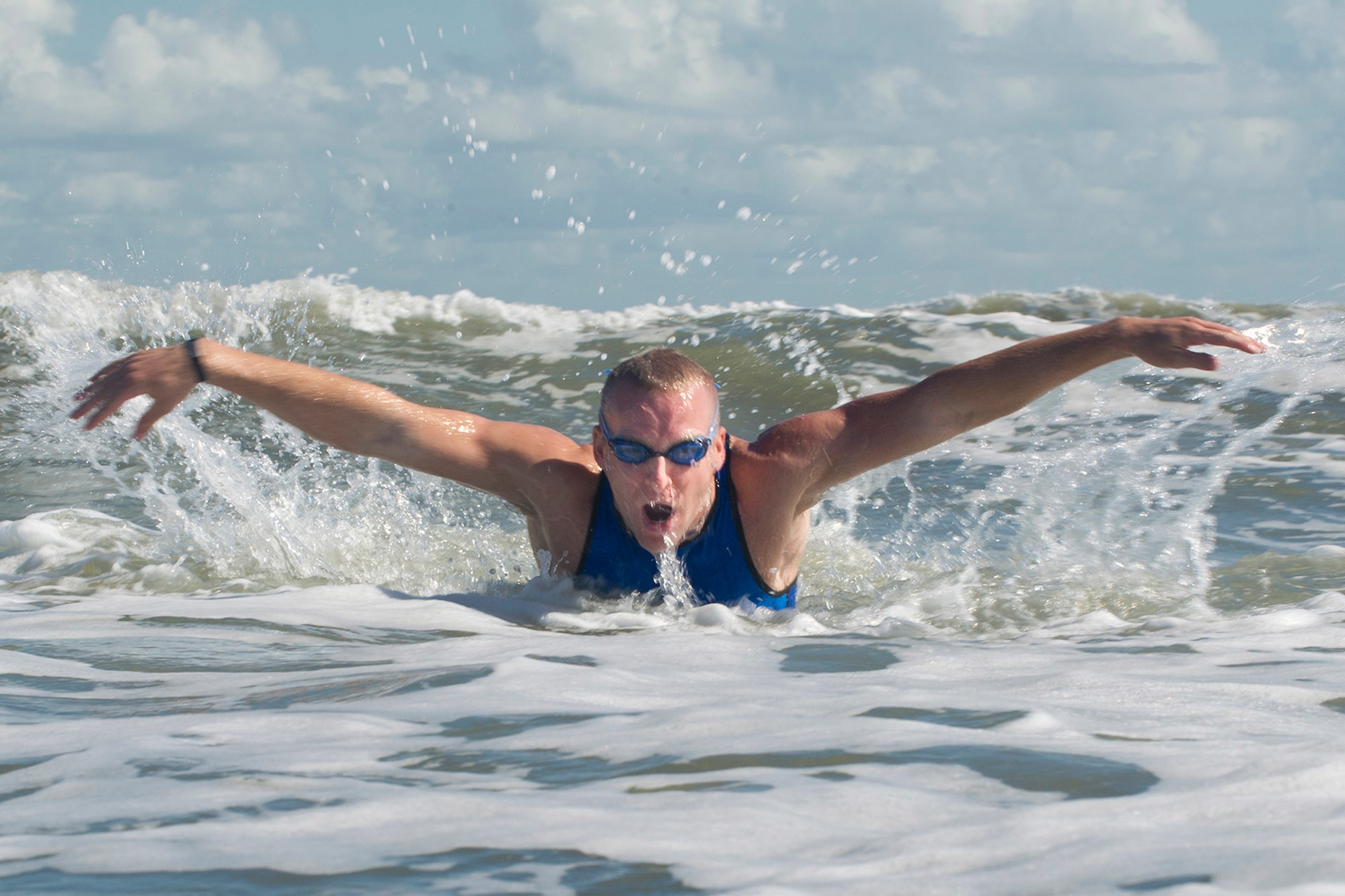 First Lt. Carl Eichert, a special nuclear events analyst for the Air Force Technical Applications Center, Patrick AFB, Fla., comes up for air while swimming in the Atlantic Ocean off Florida’s Space Coast as he trains for the 2018 Ironman World Competition in Hawaii. (U.S. Air Force photo by Phillip C. Sunkel IV)
