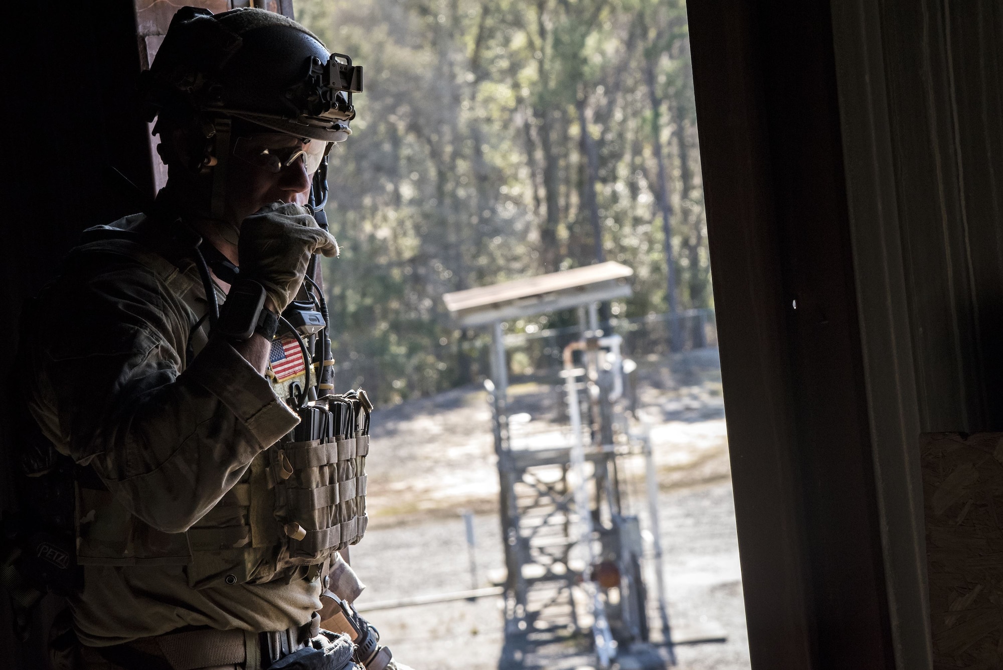A pararesueman from the 38th Rescue Squadron (RQS) speaks on a radio during a full mission profile exercise, Dec. 12, 2017, at Moody Air Force Base, Ga. During the training, the 38th RQS recovered victims while under enemy fire to prepare for future search and rescue missions and to assess their unit’s ability to work cohesively to accomplish the mission. (U.S. Air Force photo by Airman Eugene Oliver)