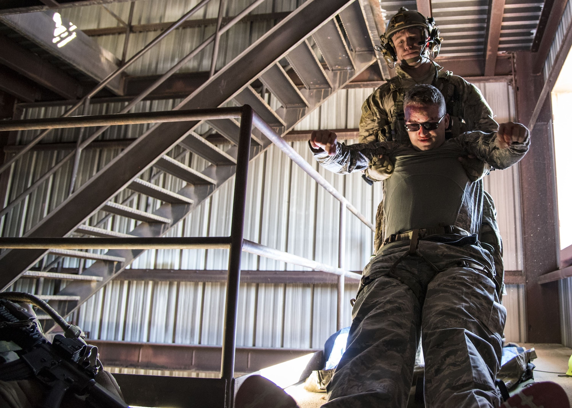 A pararescueman from the 38th Rescue Squadron (RQS) drags simulated victim Airman Jesse Lowe, 23d Security Forces Squadron fireteam member, to safety during a full mission profile exercise, Dec. 12, 2017, at Moody Air Force Base, Ga. During the training, the 38th RQS recovered victims while under enemy fire to prepare for future search and rescue missions and to assess their unit’s ability to work cohesively to accomplish the mission. (U.S. Air Force photo by Airman Eugene Oliver)
