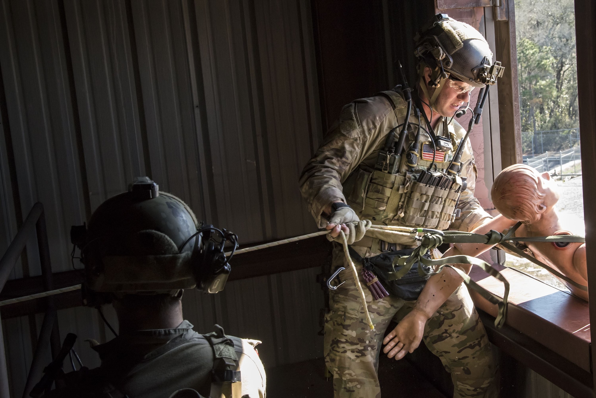 Pararescuemen from the 38th Rescue Squadron (RQS) propel a mannequin out of a window during a full mission profile exercise, Dec. 12, 2017, at Moody Air Force Base, Ga. During the training, the 38th RQS recovered victims while under enemy fire to prepare for future search and rescue missions and to assess their unit’s ability to work cohesively to accomplish the mission. (U.S. Air Force photo by Airman Eugene Oliver)