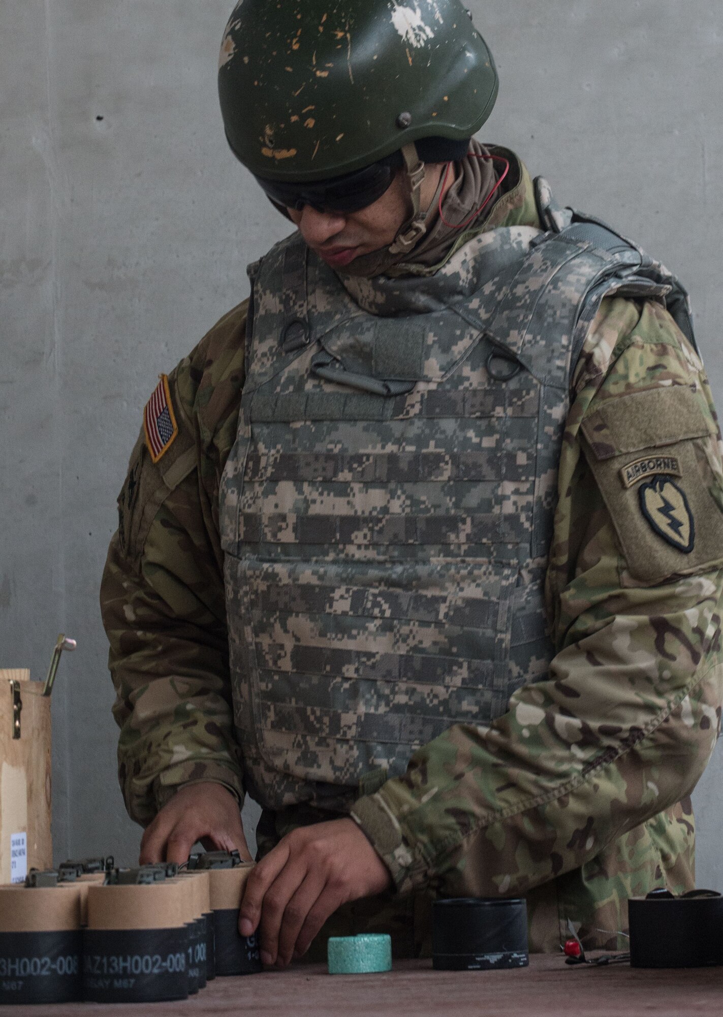 A paratrooper assigned to 3rd Battalion, 509th Parachute Infantry Regiment, 4th Infantry Brigade Combat Team (Airborne), 25th Infantry Division, U.S. Army Alaska, prepares M67 fragmentation grenades for live-fire training at Kraft Range on Joint Base Elmendorf-Richardson, Alaska, Dec. 12, 2017. A ‘pit’ noncommissioned officer supervised the Soldiers throwing grenades to maintain a safe instructional environment, enforce precaution standards, and direct them on proper handling of explosives. The fragmentation hand grenade has a lethal radius of five meters and can produce casualties up to 15 meters, dispersing fragments as far as 230 meters.