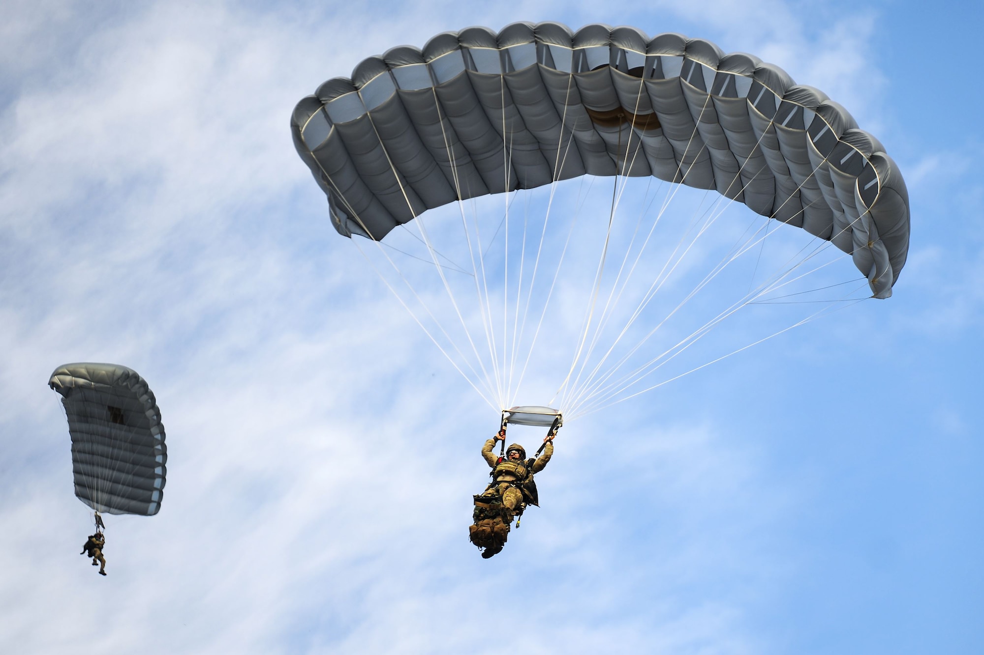 Pararescuemen from the 38th Rescue Squadron (RQS) parachute from an HC-130J Combat King II during a full mission profile exercise, Dec. 14, 2017, at Moody Air Force Base Ga. During the training, the 38th RQS recovered victims while under enemy fire to prepare for future search and rescue missions and to assess their unit’s ability to work cohesively to accomplish the mission. (U.S. Air Force photo by Airman Eugene Oliver)