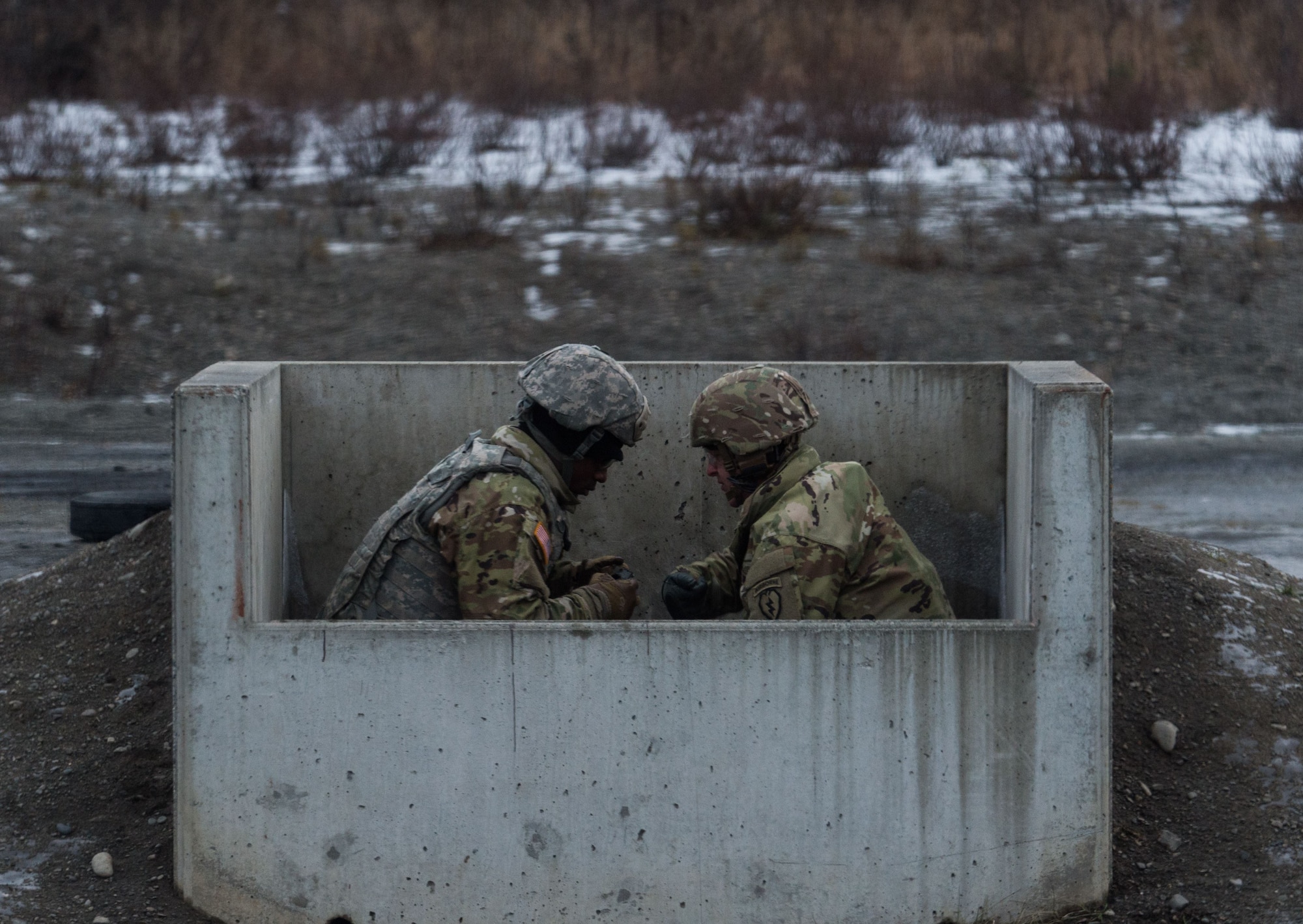 Paratroopers assigned to 3rd Battalion, 509th Parachute Infantry Regiment, 4th Infantry Brigade Combat Team (Airborne), 25th Infantry Division, U.S. Army Alaska, conduct M67 fragmentation grenade live fire training at Kraft Range on Joint Base Elmendorf-Richardson, Alaska, Dec. 12, 2017. A ‘pit’ noncommissioned officer supervised the Soldiers throwing grenades to maintain a safe instructional environment, enforce precaution standards, and direct them on proper handling of explosives. The fragmentation hand grenade has a lethal radius of five meters and can produce casualties up to 15 meters, dispersing fragments as far as 230 meters.