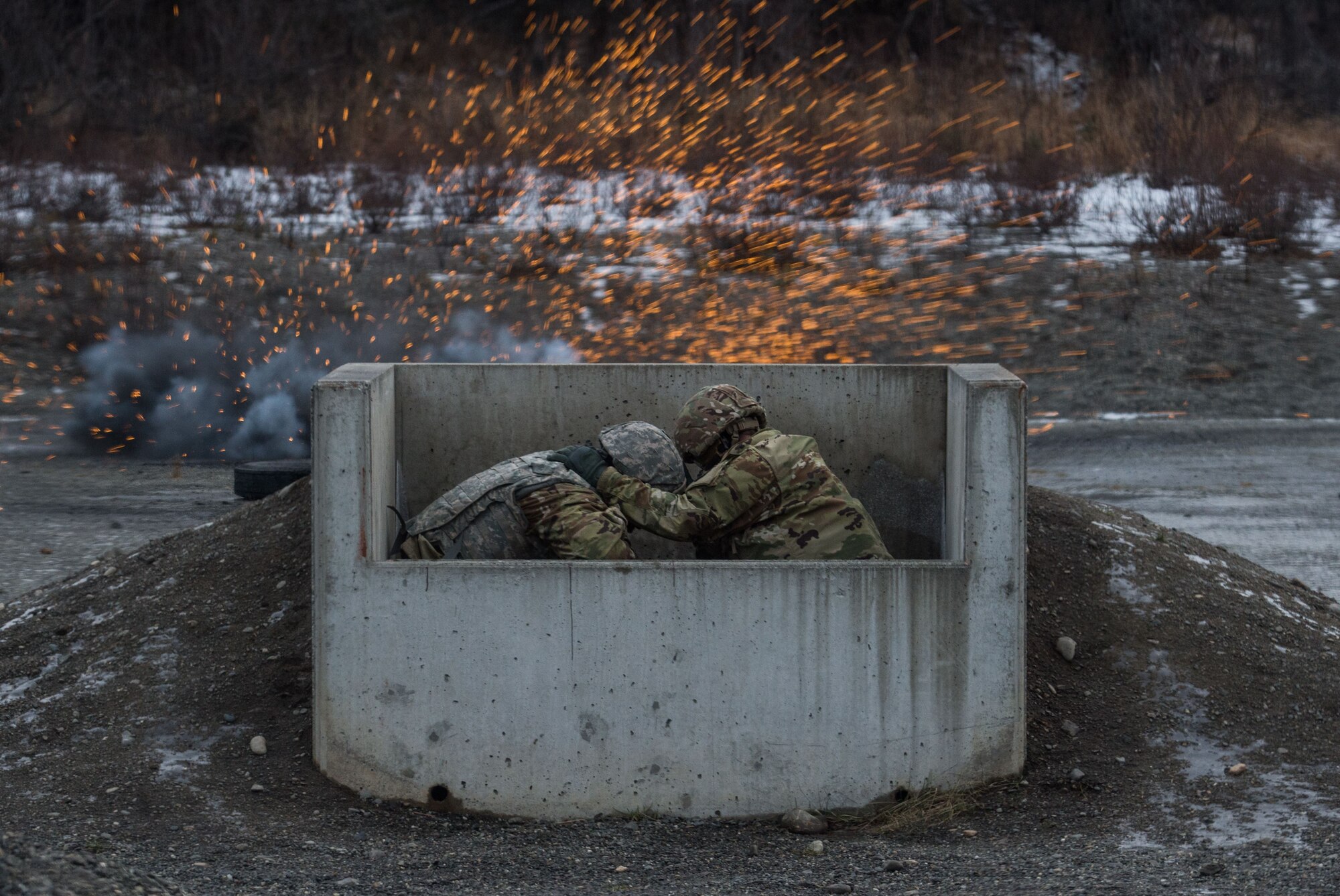 Paratroopers assigned to 3rd Battalion, 509th Parachute Infantry Regiment, 4th Infantry Brigade Combat Team (Airborne), 25th Infantry Division, U.S. Army Alaska, take cover while conducting M67 fragmentation grenade live fire training at Kraft Range on Joint Base Elmendorf-Richardson, Alaska, Dec. 12, 2017. A ‘pit’ noncommissioned officer supervised the Soldiers throwing grenades to maintain a safe instructional environment, enforce precaution standards, and direct them on proper handling of explosives. The fragmentation hand grenade has a lethal radius of five meters and can produce casualties up to 15 meters, dispersing fragments as far as 230 meters.