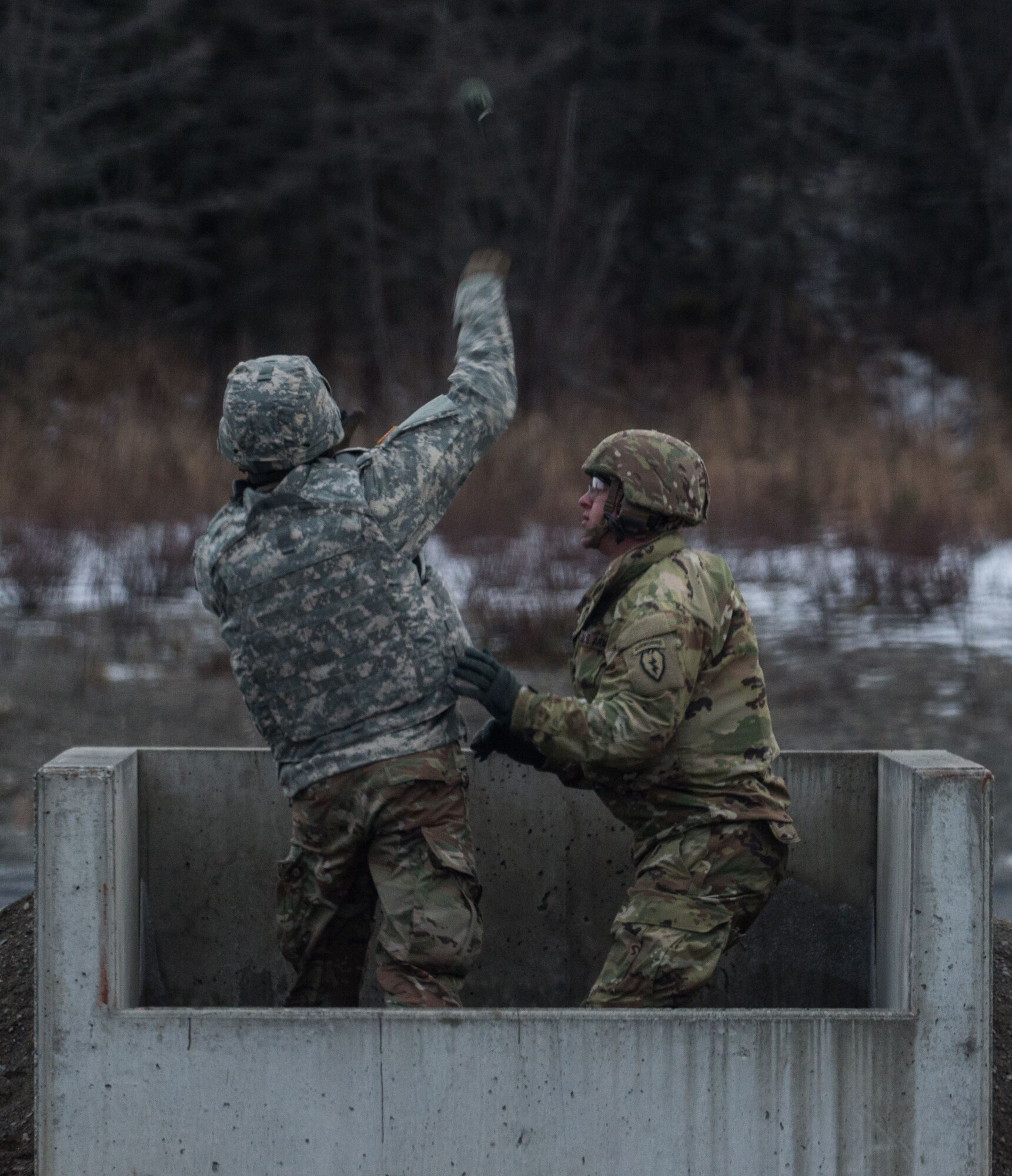A paratrooper assigned to 3rd Battalion, 509th Parachute Infantry Regiment, 4th Infantry Brigade Combat Team (Airborne), 25th Infantry Division, U.S. Army Alaska, throws an M67 fragmentation grenade during live fire training at Kraft Range on Joint Base Elmendorf-Richardson, Alaska, Dec. 12, 2017. A ‘pit’ noncommissioned officer supervised the Soldiers throwing grenades to maintain a safe instructional environment, enforce precaution standards, and direct them on proper handling of explosives. The fragmentation hand grenade has a lethal radius of five meters and can produce casualties up to 15 meters, dispersing fragments as far as 230 meters.