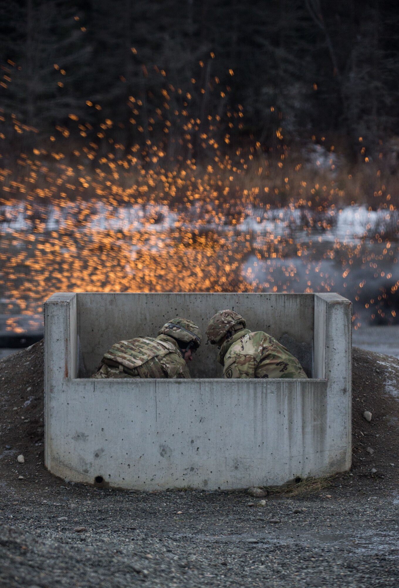 Paratroopers assigned to 3rd Battalion, 509th Parachute Infantry Regiment, 4th Infantry Brigade Combat Team (Airborne), 25th Infantry Division, U.S. Army Alaska, take cover while conducting M67 fragmentation grenade live fire training at Kraft Range on Joint Base Elmendorf-Richardson, Alaska, Dec. 12, 2017. A ‘pit’ noncommissioned officer supervised the Soldiers throwing grenades to maintain a safe instructional environment, enforce precaution standards, and direct them on proper handling of explosives. The fragmentation hand grenade has a lethal radius of five meters and can produce casualties up to 15 meters, dispersing fragments as far as 230 meters.