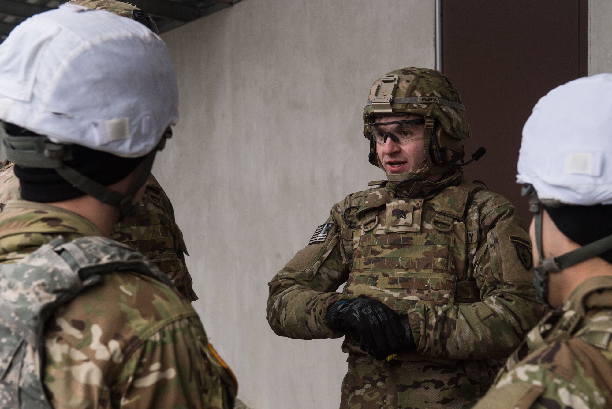 U.S. Army Sgt. Jeremy Pegram, a paratrooper assigned to Charlie Company, 3rd Battalion, 509th Parachute Infantry Regiment, 4th Infantry Brigade Combat Team (Airborne), 25th Infantry Division, U.S. Army Alaska, speaks with fellow Soldiers prior for M67 fragmentation grenade live fire training at Kraft Range on Joint Base Elmendorf-Richardson, Alaska, Dec. 12, 2017. A ‘pit’ noncommissioned officer supervised the Soldiers throwing grenades to maintain a safe instructional environment, enforce precaution standards, and direct them on proper handling of explosives. The fragmentation hand grenade has a lethal radius of five meters and can produce casualties up to 15 meters, dispersing fragments as far as 230 meters.