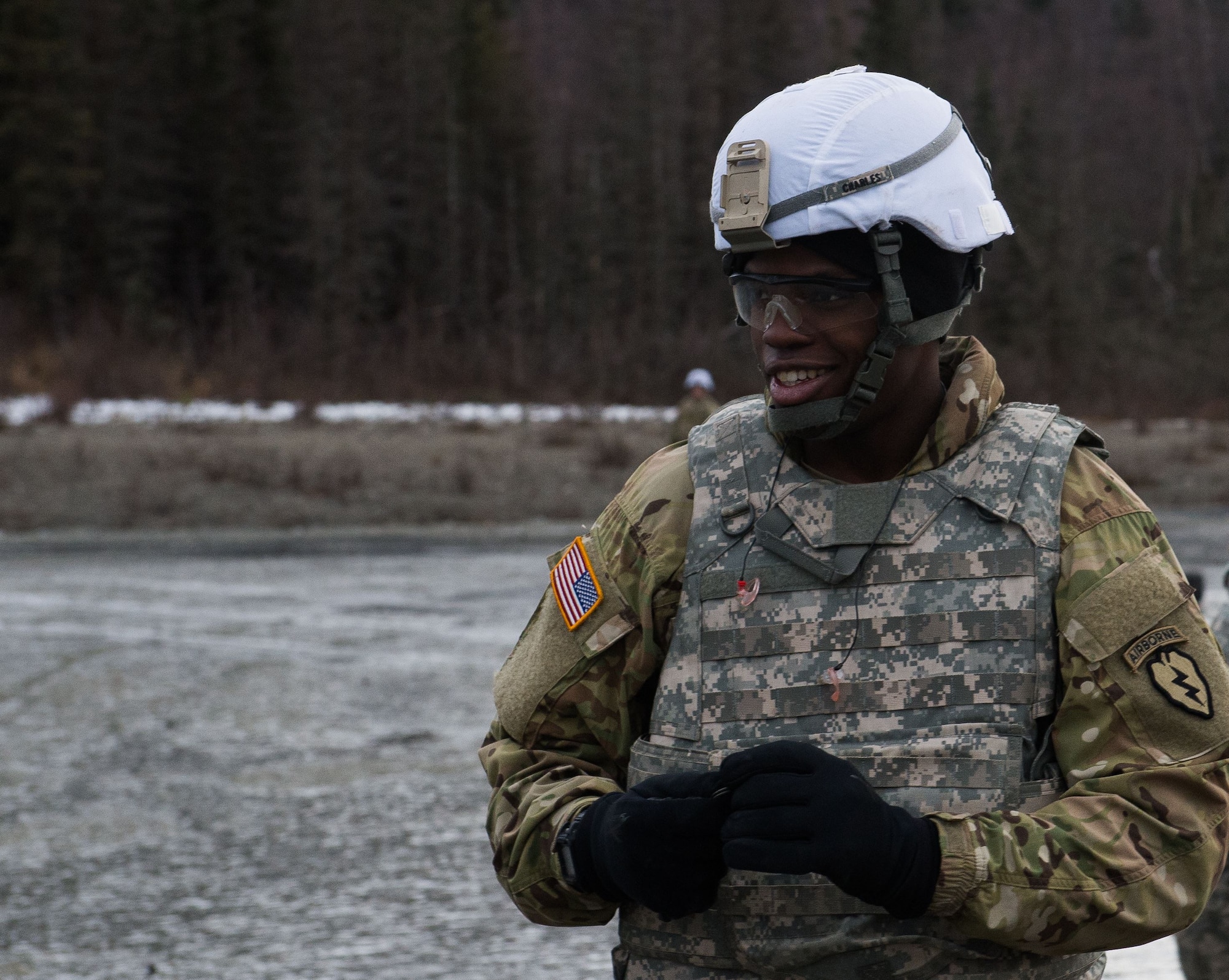 U.S. Army Pvt. Eriner Charles, a paratrooper assigned to 3rd Battalion, 509th Parachute Infantry Regiment, 4th Infantry Brigade Combat Team (Airborne), 25th Infantry Division, U.S. Army Alaska, clears debris from the range after M67 fragmentation grenade live fire training at Kraft Range on Joint Base Elmendorf-Richardson, Alaska, Dec. 12, 2017. A ‘pit’ noncommissioned officer supervised the Soldiers throwing grenades to maintain a safe instructional environment, enforce precaution standards, and direct them on proper handling of explosives. The fragmentation hand grenade has a lethal radius of five meters and can produce casualties up to 15 meters, dispersing fragments as far as 230 meters.