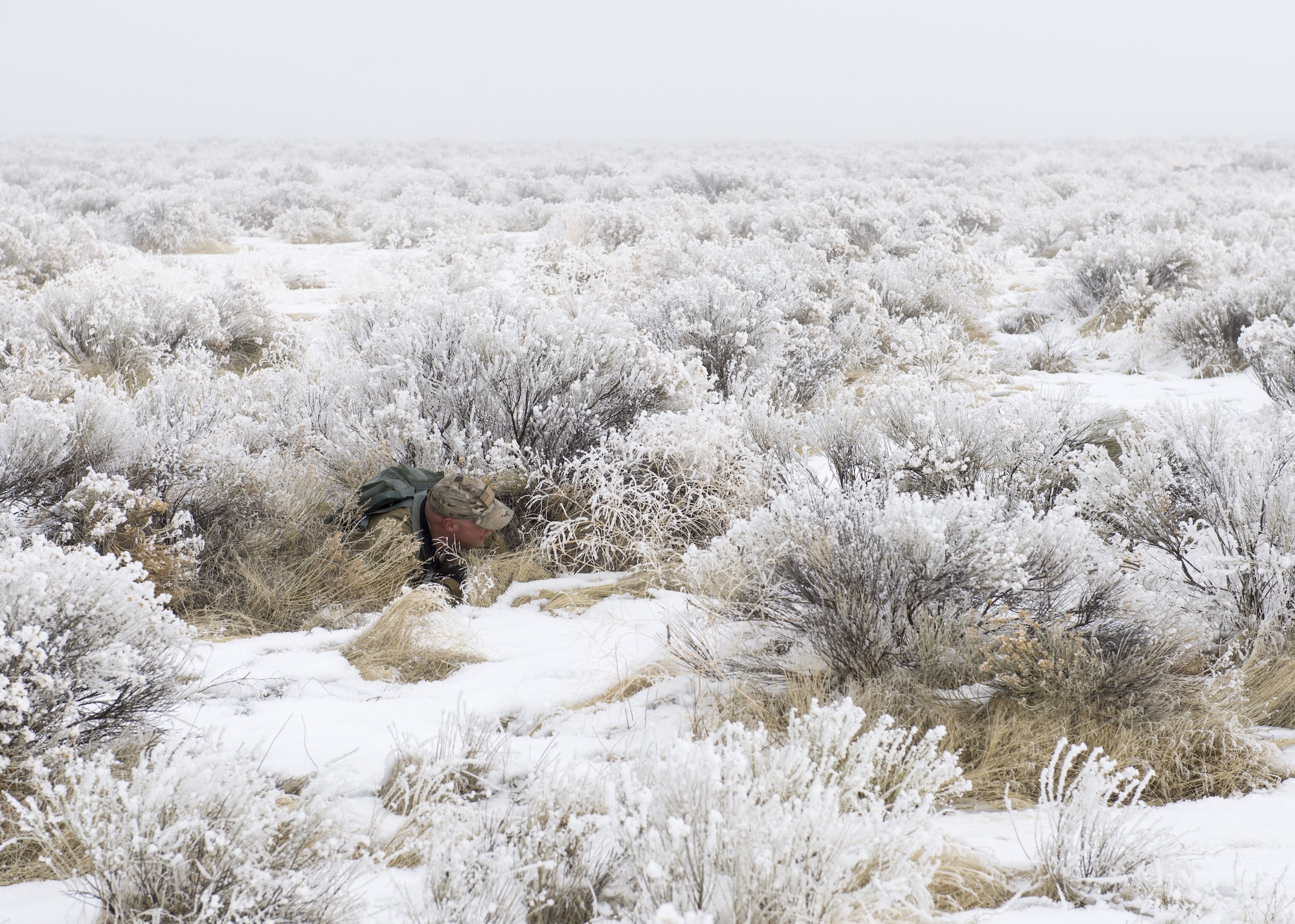 Master Sgt. Adam Young, 124th Operations Support Squadron Survival, Evasion, Resist and Escape specialist, demonstrates evasion techniques during Gunfighter Flag 18-1 Dec. 14, 2017, at Mountain Home Air Force Base, Idaho. Gunfighter Flag 18-1 took place Dec. 11-15, simulating joint service operations that might be encountered in a deployed environment. (U.S. Air Force photo by Airman 1st Class Jeremy D. Wolff)