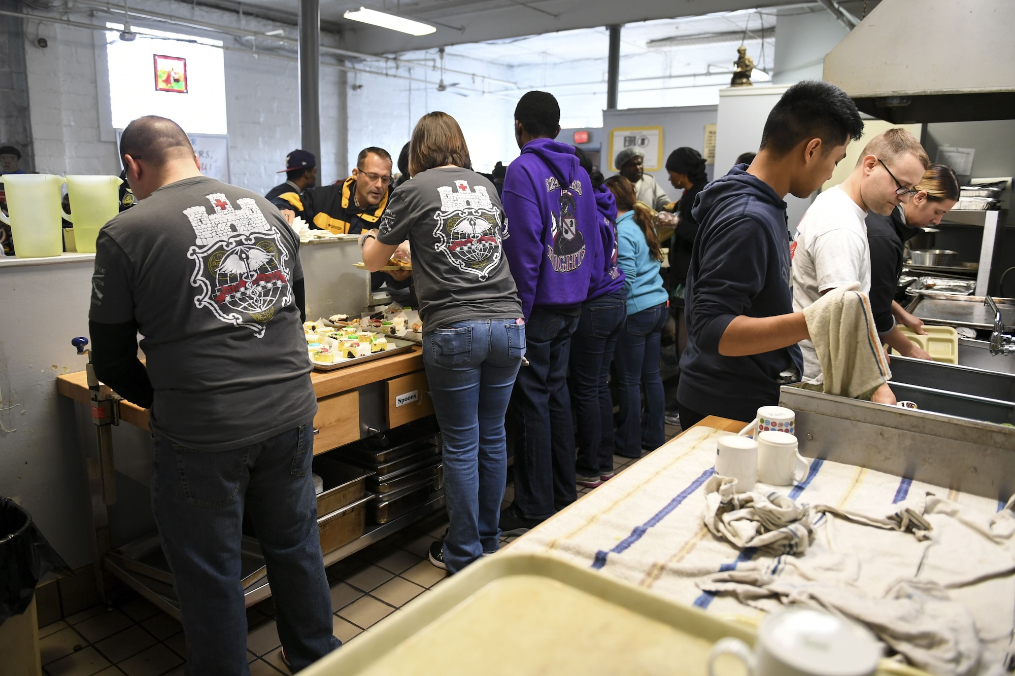 Members of the 911th Aeromedical Evacuation Squadron serve a meal and wash dishes at Jubilee Soup Kitchen, Pittsburgh, Pa., December 11, 2017. Jubilee Soup Kitchen is a nonprofit organization designed to provide community support through meals 365-days a year. (U.S. Air Force photo by Senior Airman Beth Kobily)