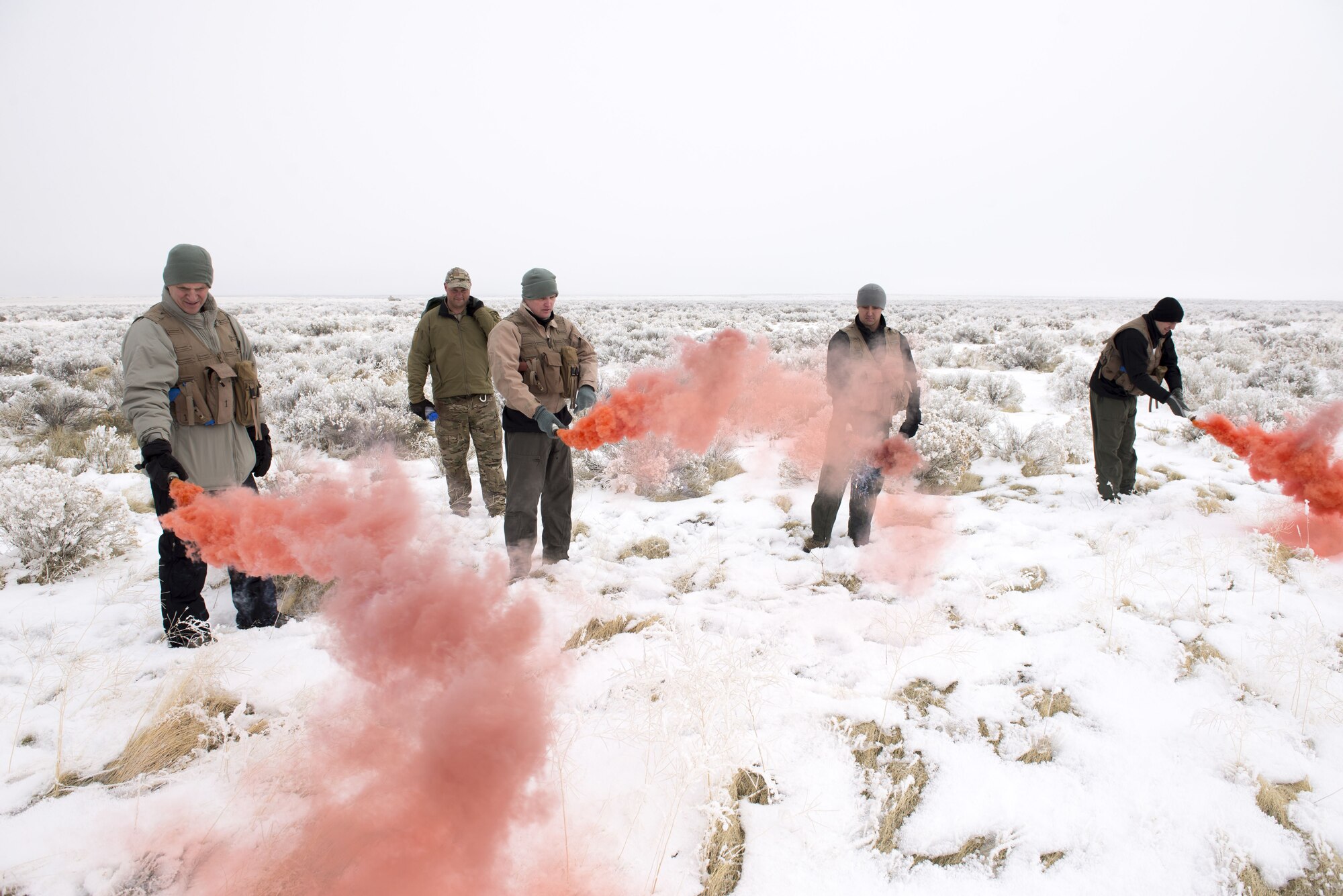 Members of the 366th Fighter Wing practice popping their signal smoke during Gunfighter Flag 18-1 Dec. 14, 2017, at Mountain Home Air Force Base, Idaho. Gunfighter Flag 18-1 took place Dec. 11-15, simulating joint service operations that might be encountered in a deployed environment. (U.S. Air Force photo by Airman 1st Class Jeremy D. Wolff)