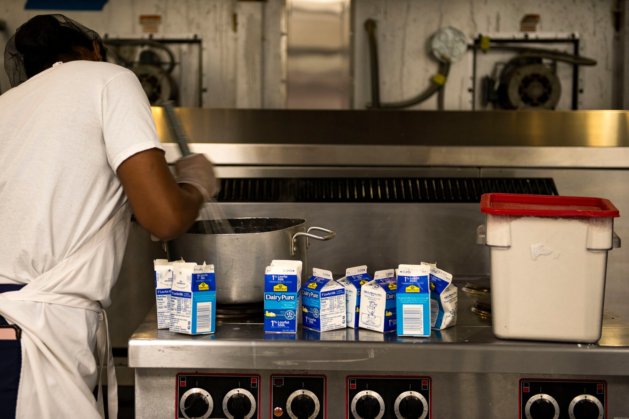 Airman 1st Class Ravin Collins, 23d Force Support Squadron food services journeyman, whisks alfredo sauce in the Georgia Pines Dining Facility (DFAC), Dec. 12, 2017, at Moody Air Force Base, Ga. Through teamwork, adaption and striving for excellence, the Georgia Pines DFAC Airmen are able to ensure Team Moody is fed and ready to finish the fight. (U.S. Air Force Base photo by Airman 1st Class Erick Requadt)