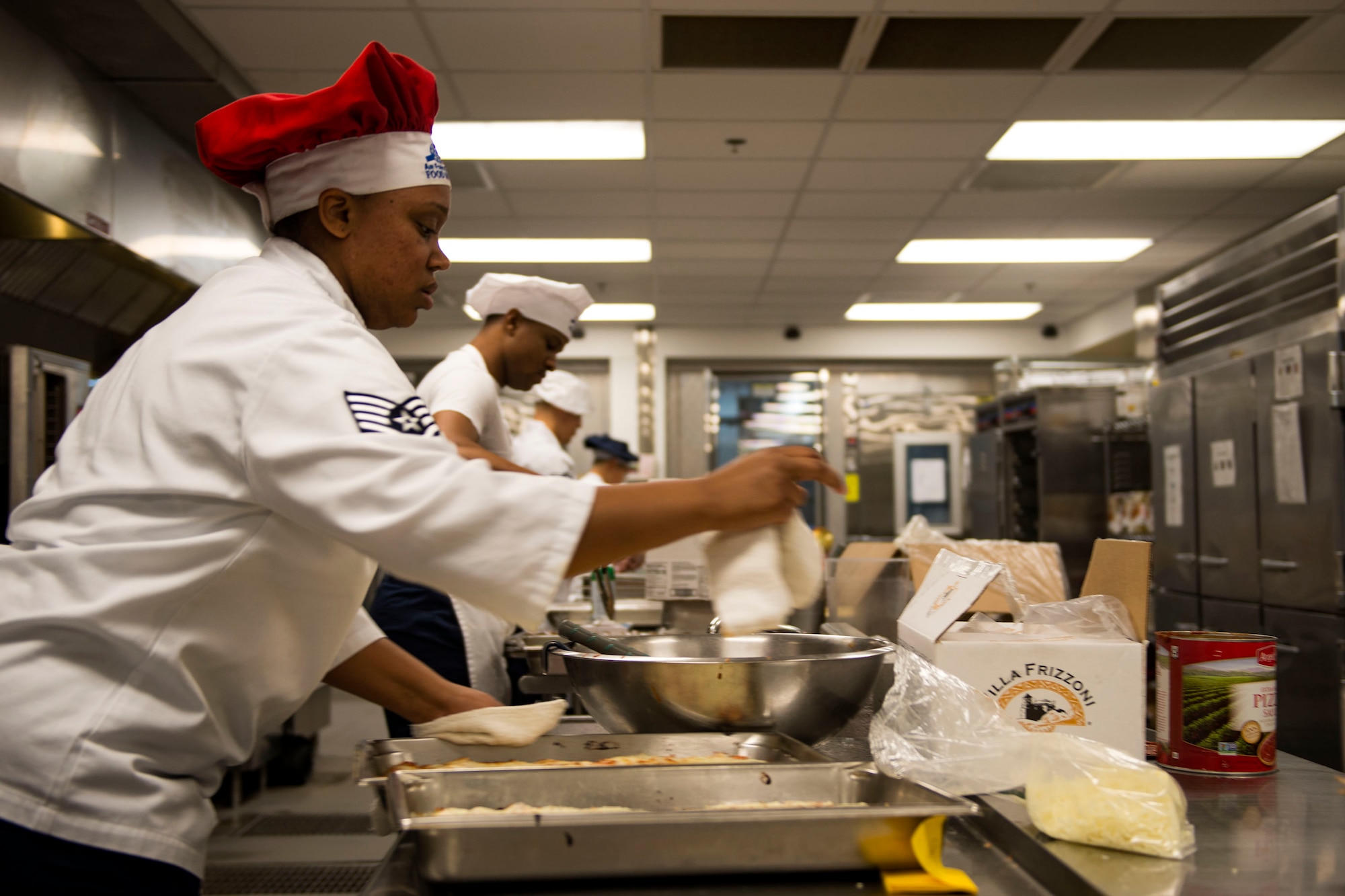 Airmen assigned to the 23d Force Support Squadron work together to get lunch ready in the Georgia Pines Dining Facility (DFAC), Dec. 12, 2017, at Moody Air Force Base, Ga. Through teamwork, adaption and striving for excellence, the Georgia Pines DFAC Airmen are able to ensure Team Moody is fed and ready to finish the fight. (U.S. Air Force Base photo by Airman 1st Class Erick Requadt)