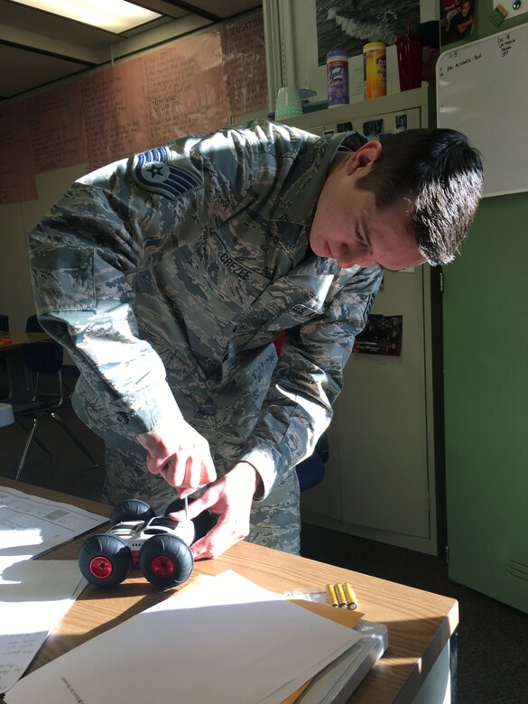 Staff Sgt. Chris Crezee, 67th Aerial Port Squadron, acts as toymaker during a Christmas party at Mound Fort Junior High in Ogden Dec. 15.