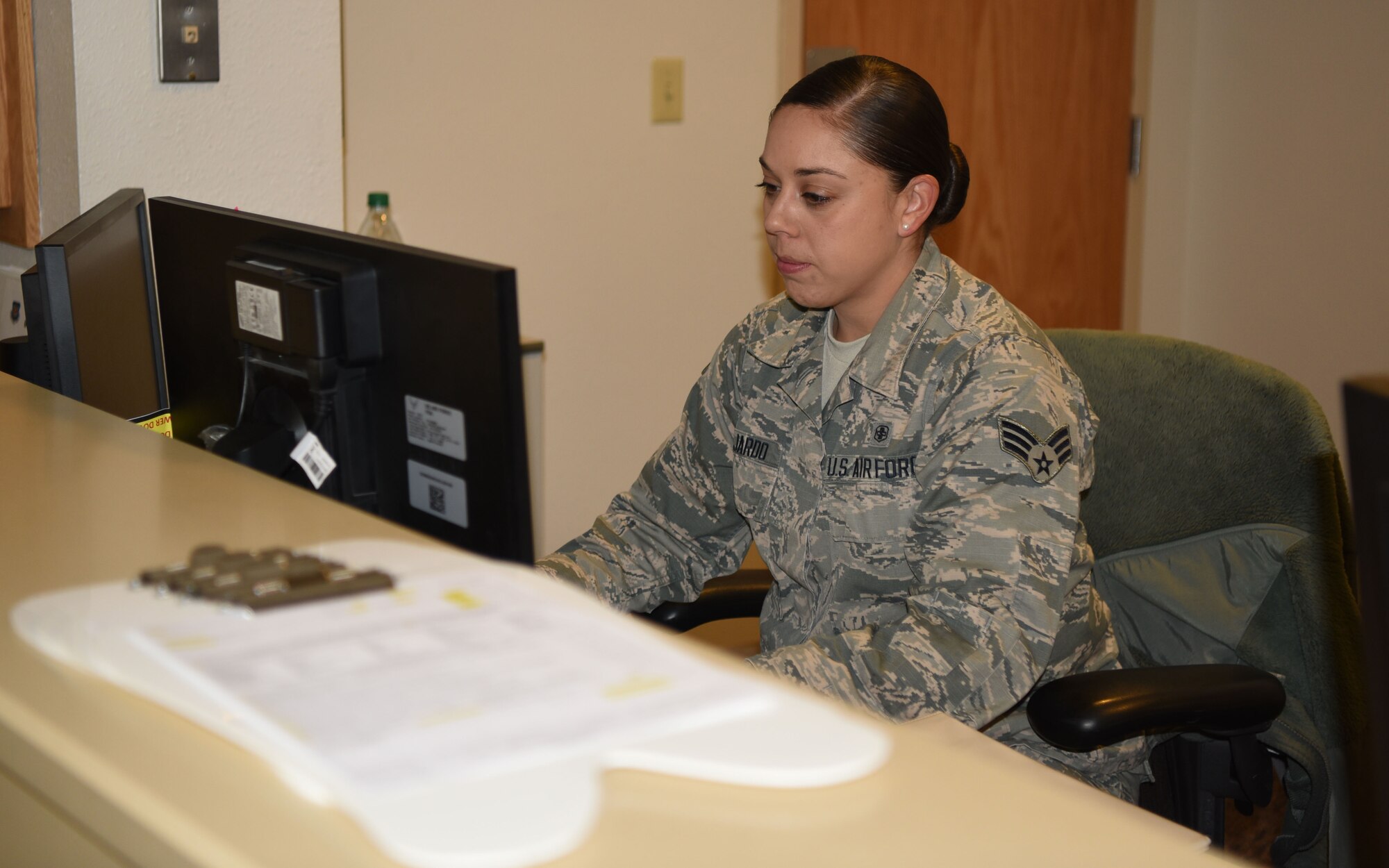 Senior Airman Isabel Guajardo, 90th Medical Group dental assistant, works at the front desk of the dental clinic at F.E. Warren Air Force Base, Wyo., on Dec. 15, 2017. Isabel and her husband work together in the clinic and have proven it is possible to pursue success together at home and work.