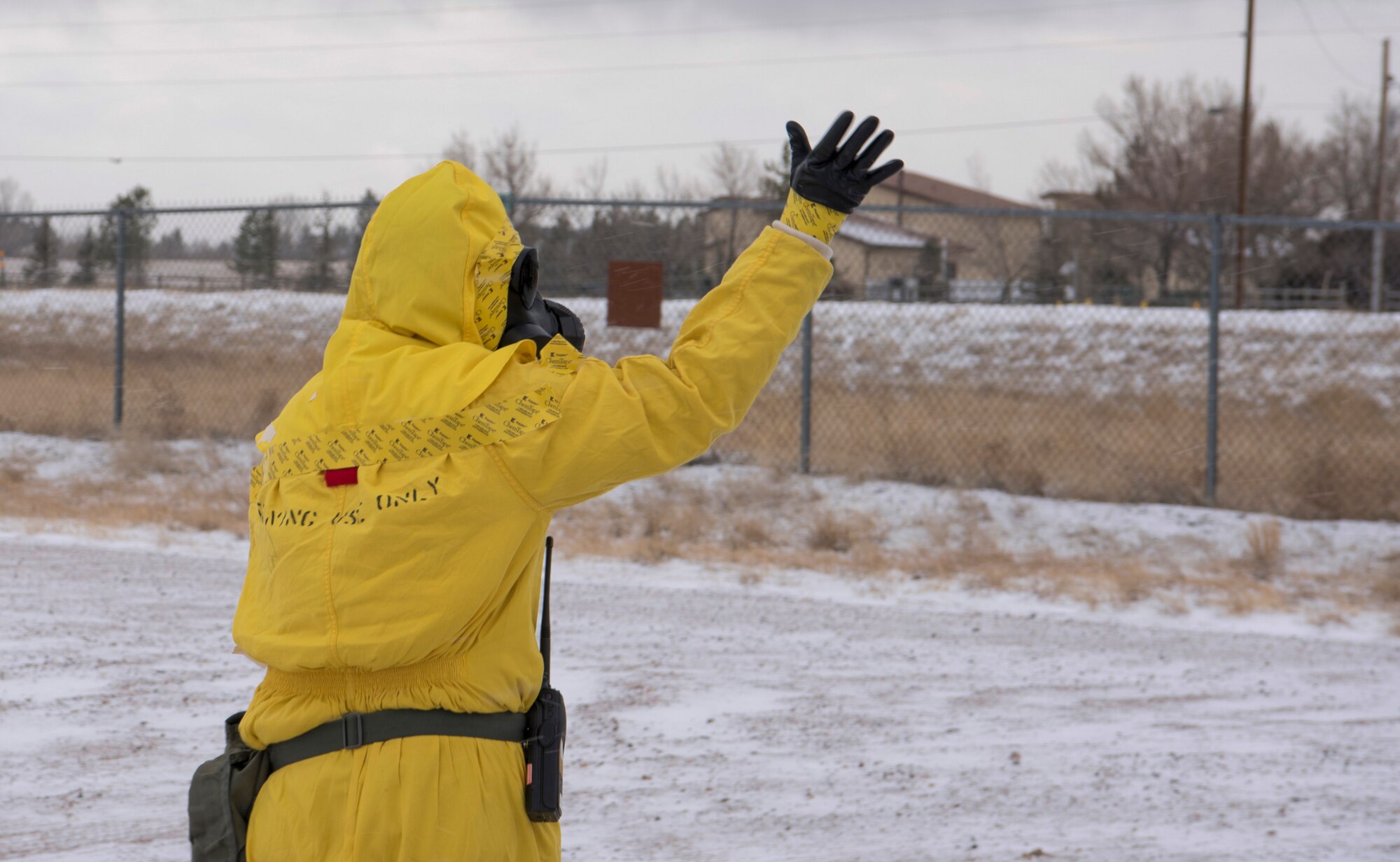 Senior Airman Mckenzie Williams, 90th Civil Engineering Squadron emergency management technician, signals to Explosive Ordnance Disposal that it is safe to proceed in to the cordon during an exercise on F.E. Warren Air Force Base, Wyo., Dec. 14, 2017. Exercises are paramount in keeping Airmen ready to jump into action when the need arises. (U.S. Air Force photo by Airman 1st Class Braydon Williams)