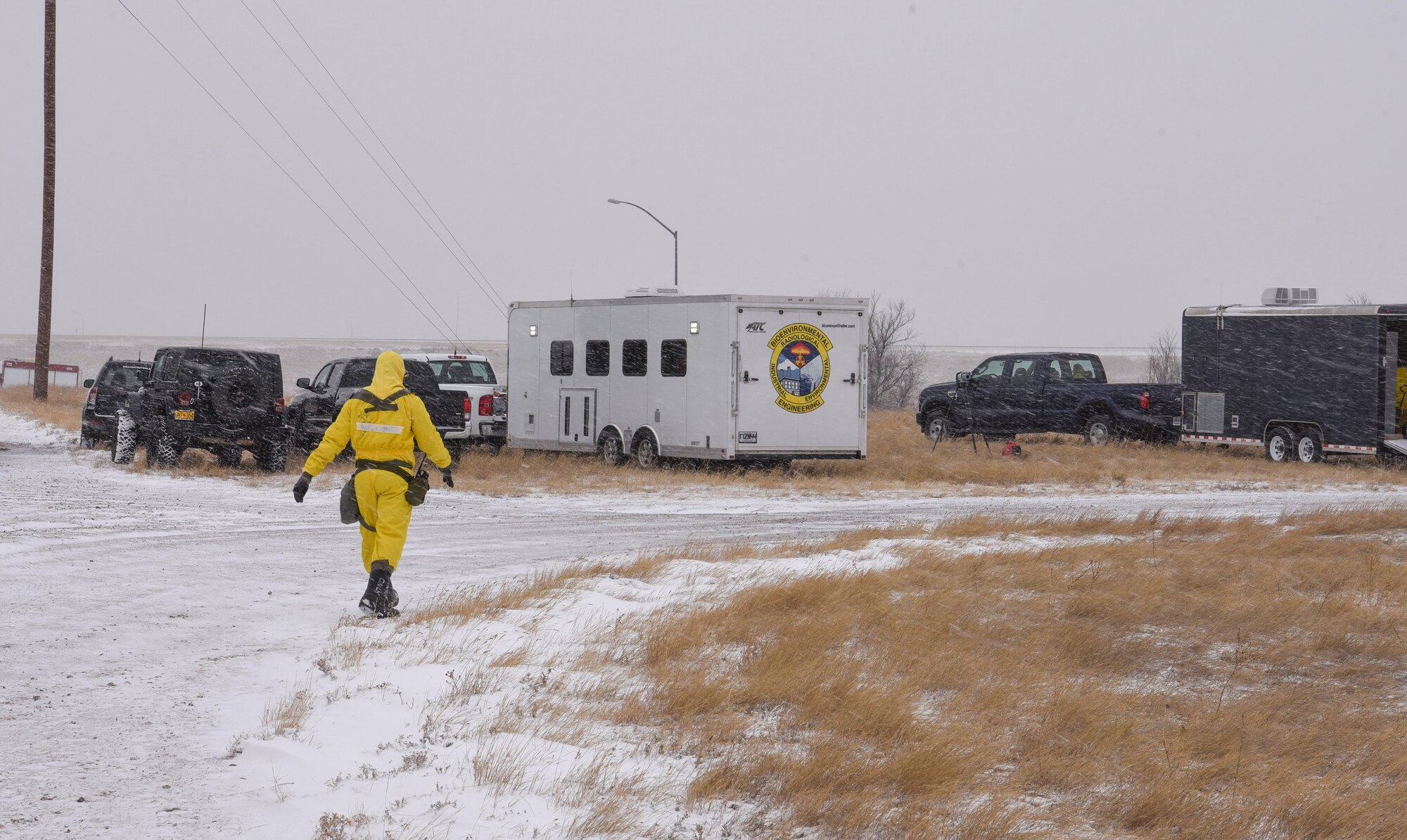 Senior Airman Mckenzie Williams, 90th Civil Engineering Squadron emergency management technician, walks to the emergency response trailer during an exercise on F.E. Warren Air Force Base, Wyo., Dec. 14, 2017. Emergency Management works with Explosive Ordinance Disposal, Fire Rescue and Bio-environmental to clean up after nuclear incidents of any kind. (U.S. Air Force photo by Airman 1st Class Braydon Williams)