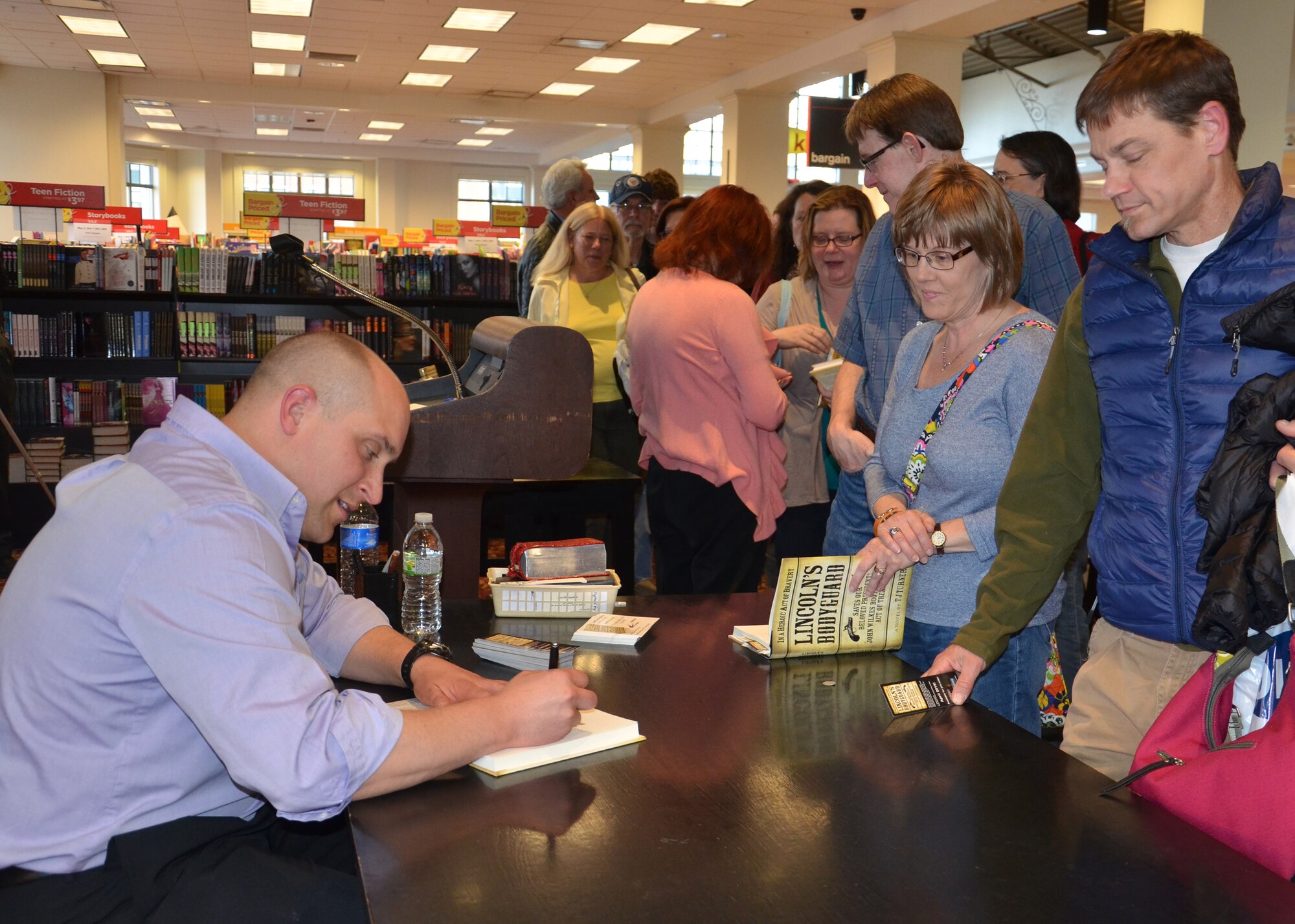 AFRL materials engineer TJ Turner signs book copies