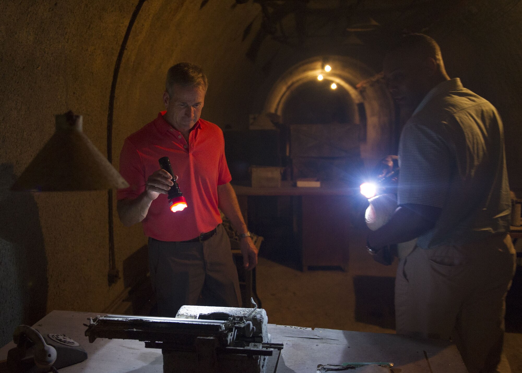 Gen. Terrence J. O’Shaughnessy, Pacific Air Forces commander and Chief Master Sgt. Anthony Johnson, PACAF command chief, examine a typewriter in a bunker on Corregidor Island, Philippines, during a historic tour of the island Dec. 10.