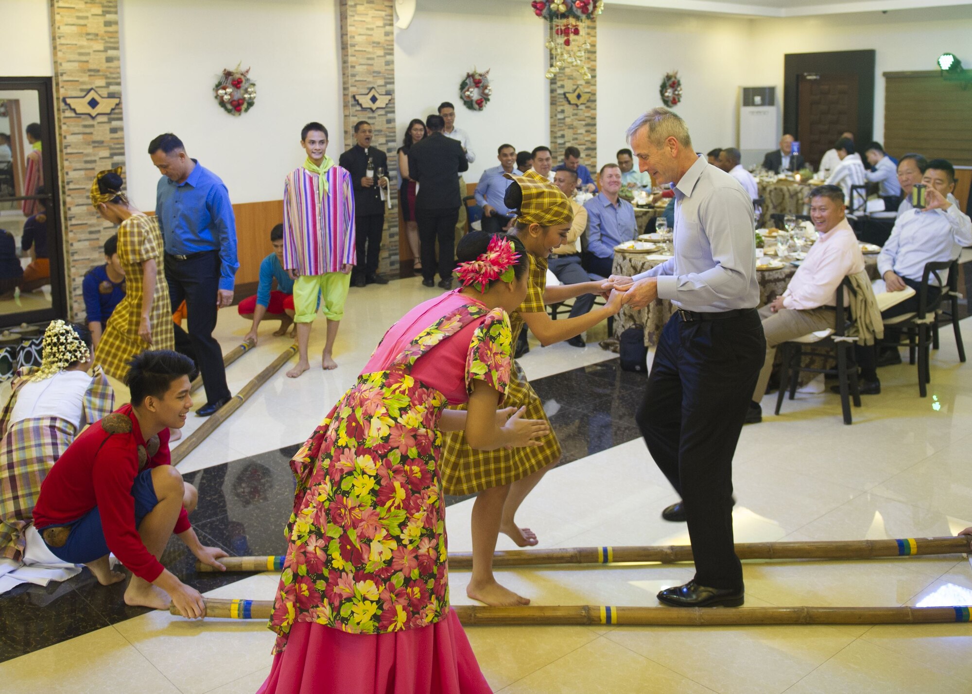 Gen. Terrence J. O’Shaughnessy, Pacific Air Forces commander, and Lt. Gen. Galileo Gerard Kintanar, Philippine Air Force commanding general, learn a traditional Filipino dance during a dinner hosted by the PAF, Manila, Philippines Dec. 11.