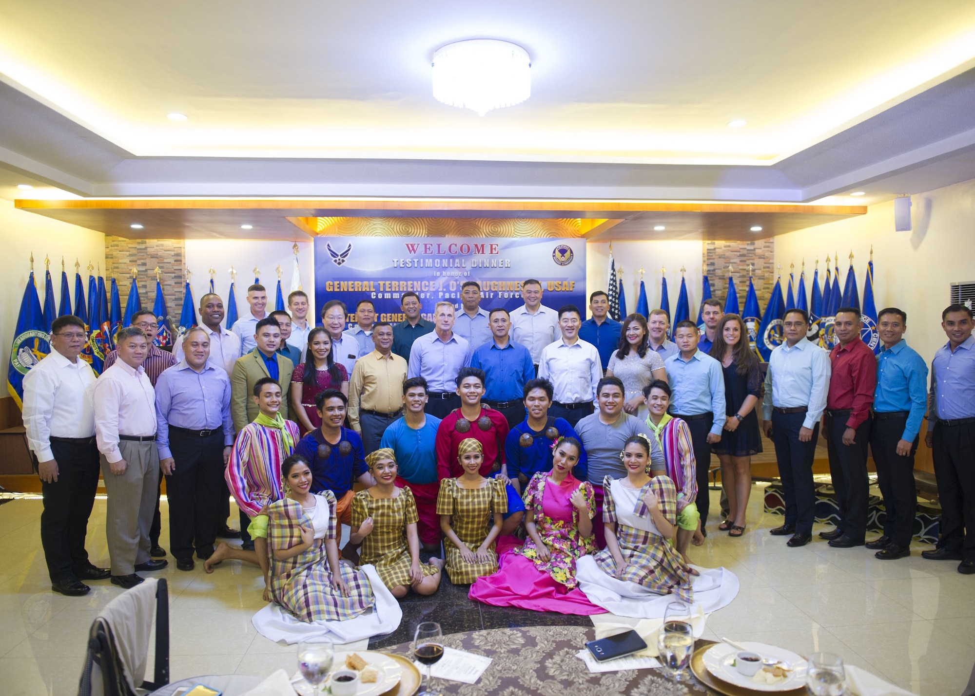 Gen. Terrence J. O’Shaughnessy, Pacific Air Forces commander, Lt. Gen. Galileo Gerard Kintanar, Philippine Air Force commanding general, Chief Master Sgt. Anthony Johnson, PACAF command chief, and staffs pose for a group photo with the cultural performers following a dinner hosted by the PAF, Manila, Philippines Dec. 11.