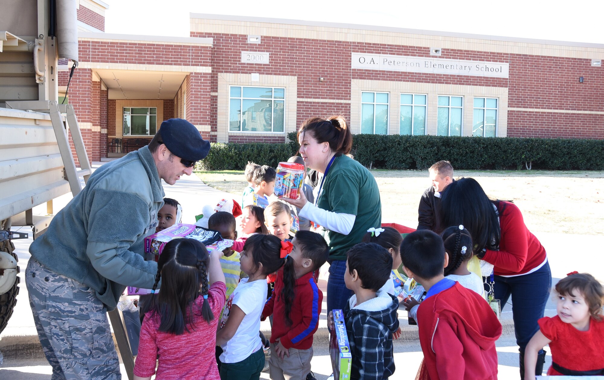 Tech. Sgt. Chad Ragland, a 301st Security Forces Squadron member, collects toys from local elementary students Friday, Dec. 15, 2017, during the unit's annual Ruck for Kids drive. The toys are for kids who are hospitalized at Cook Childrenʼs
Medical Center in Fort Worth, Texas. Students from O.A. Peterson, Haslet, and Sendera Ranch Elementary schools participated in the drive. (U.S. Air Force photos by Tech. Sgt. Melissa Harvey)