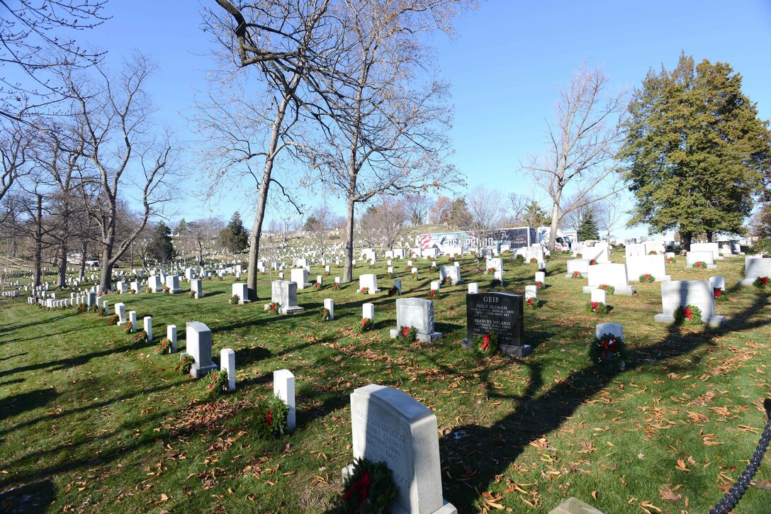 Headstones are adorned with wreaths.