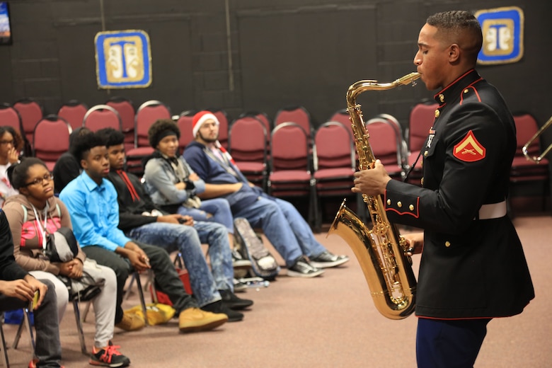 Lance Cpl. Erik Wright plays the saxophone at McCleur High School, Dec. 12, in Florissant, Missouri. Marines with the Marine Corps New Orleans Band entertained students and teachers at various high schools in and around the St. Louis area, Dec. 12-14, during its winter recruiting tour. Aside from playing music, the New Orleans, Louisiana-based Marines also educated and informed students and teachers about what life is like being a band Marine. (Official U.S. Marine Corps photo by GySgt. Bryan A. Peterson/Released)