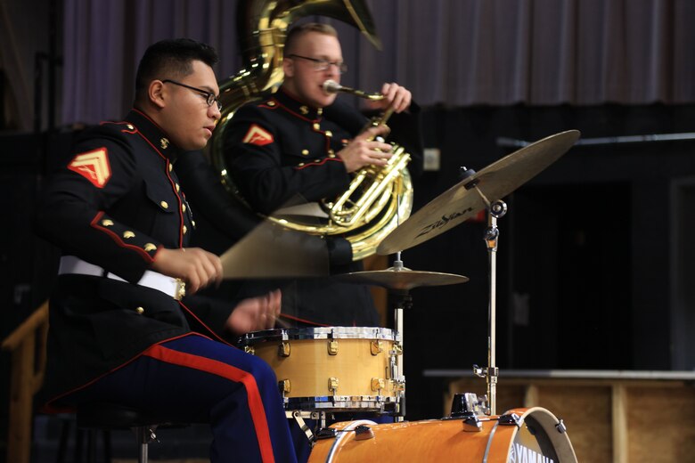 Corporal Vincente Rodriguez jams out with the drumset at McCleur High School, Dec. 12, in Florissant, Missouri. Marines with the Marine Corps New Orleans Band entertained students and teachers at various high schools in and around the St. Louis area Dec. 12-14 during its winter recruiting tour. Aside from playing music, the New Orleans, Louisiana-based Marines also educated and informed students and teachers about what life is like being a band Marine. (Official U.S. Marine Corps photo by GySgt. Bryan A. Peterson/Released)